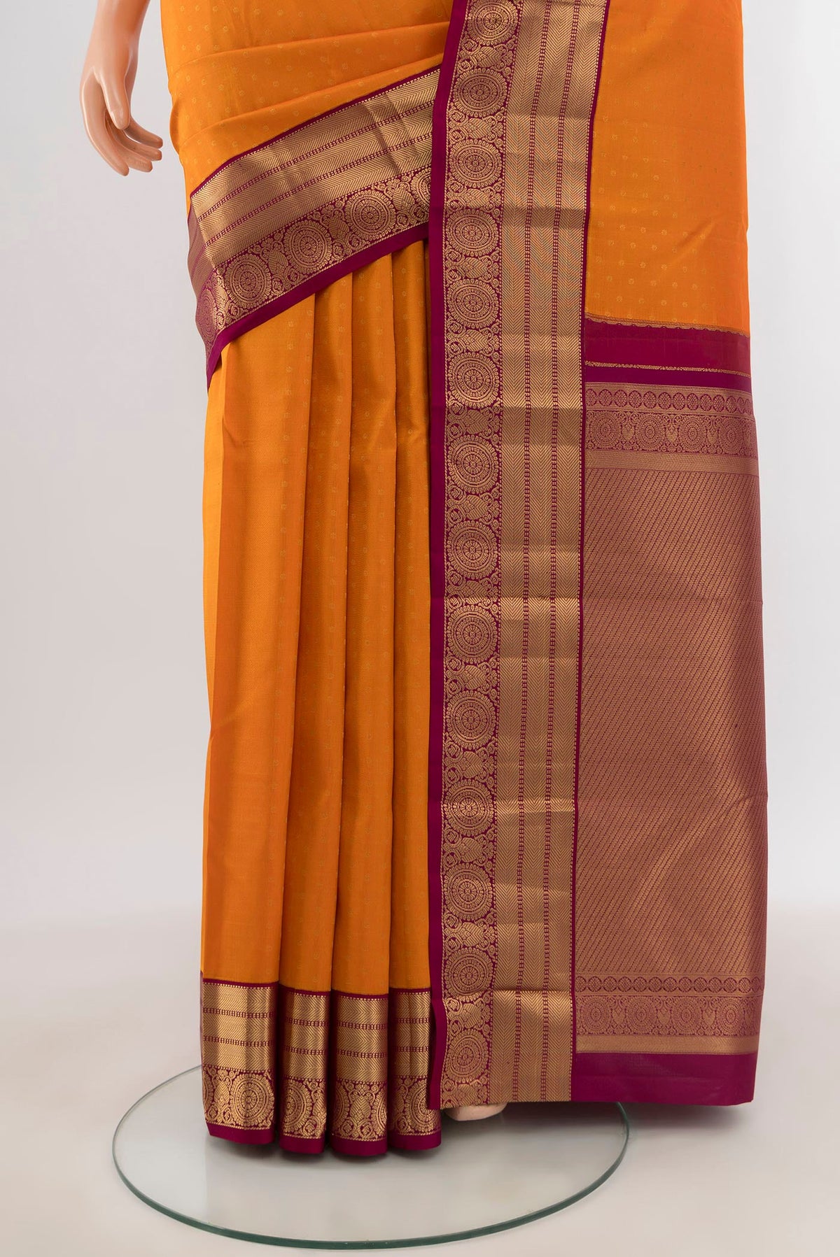 Pleats and pallu of Orange Kanchipuram Silk Saree with Zari Butta on the body and Zari Border. 