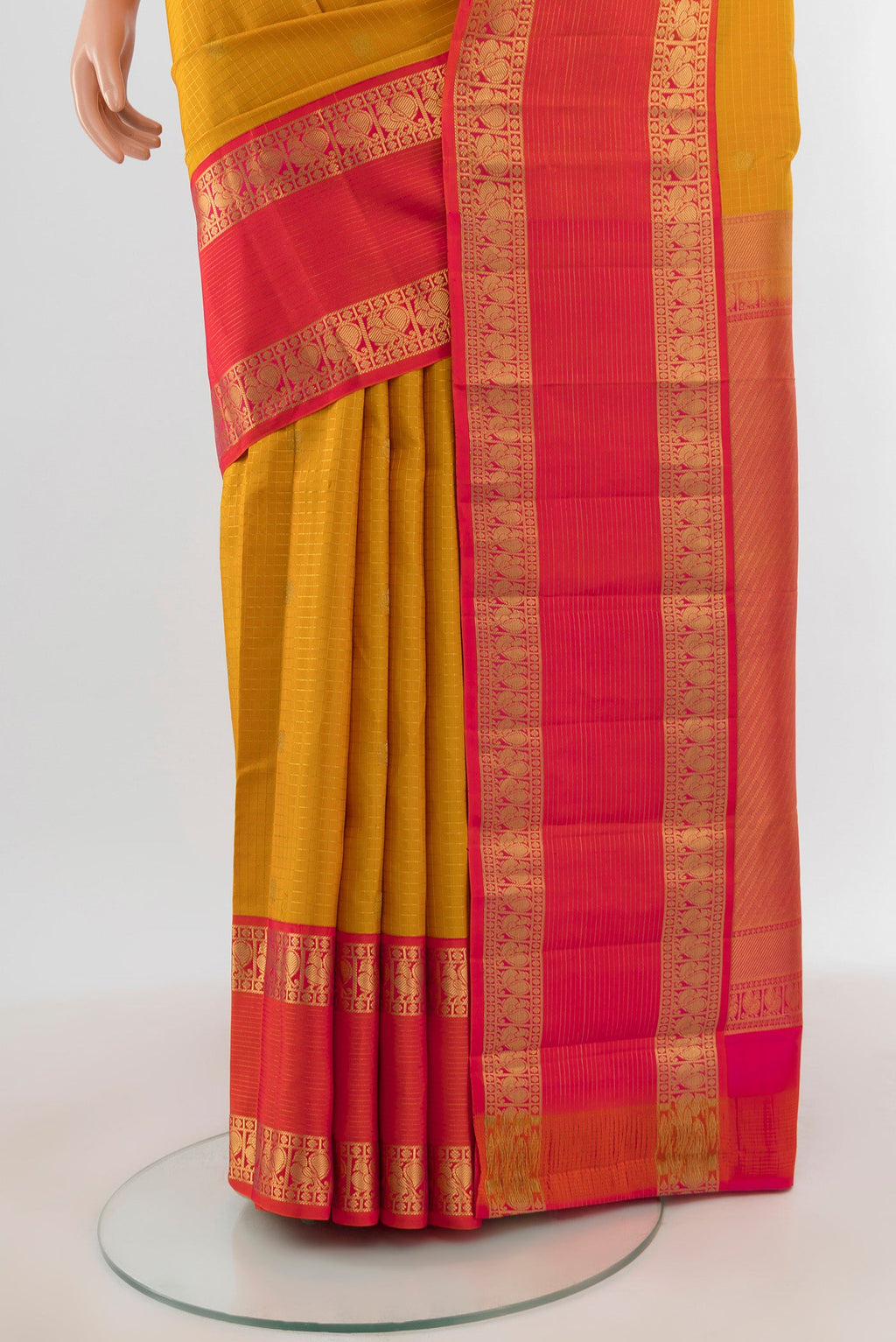 Pleats and pallu of Mustard Kanchipuram Silk Saree with Checked design on the body and Zari Border. 