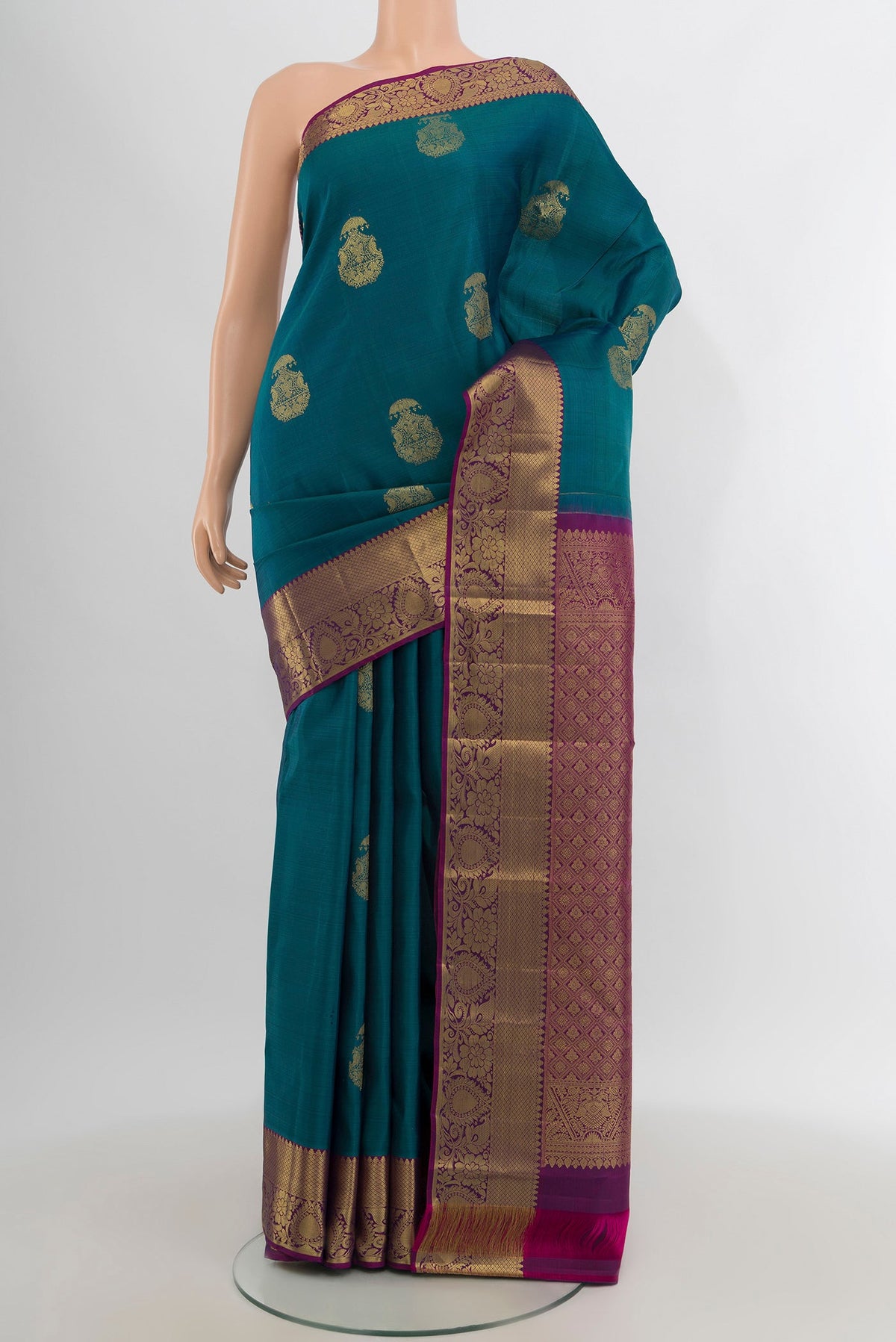 Peacock Blue Kanchipuram Silk Saree with Zari Butta on the body and Zari Border.  displayed on a mannequin