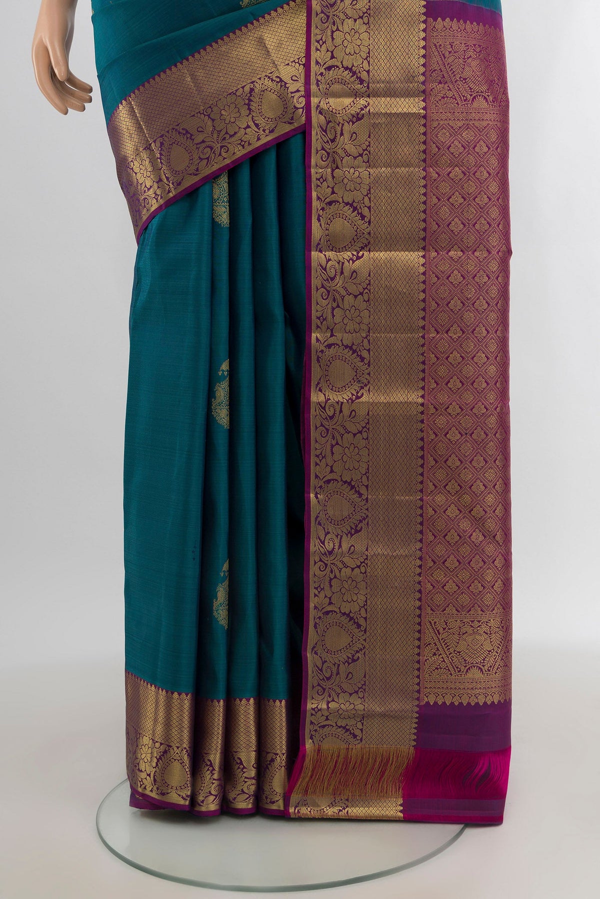 Pleats and pallu of Peacock Blue Kanchipuram Silk Saree with Zari Butta on the body and Zari Border. 