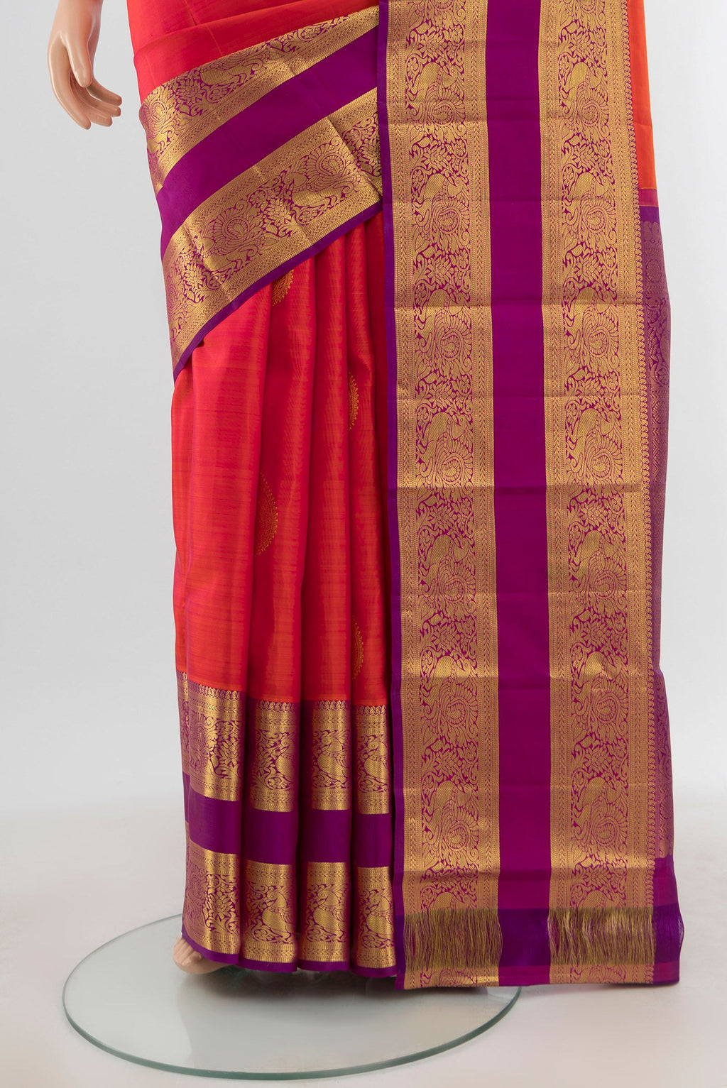Pleats and pallu of Brick Orange Kanchipuram Silk Saree with Zari Butta on the body and Zari Border. 