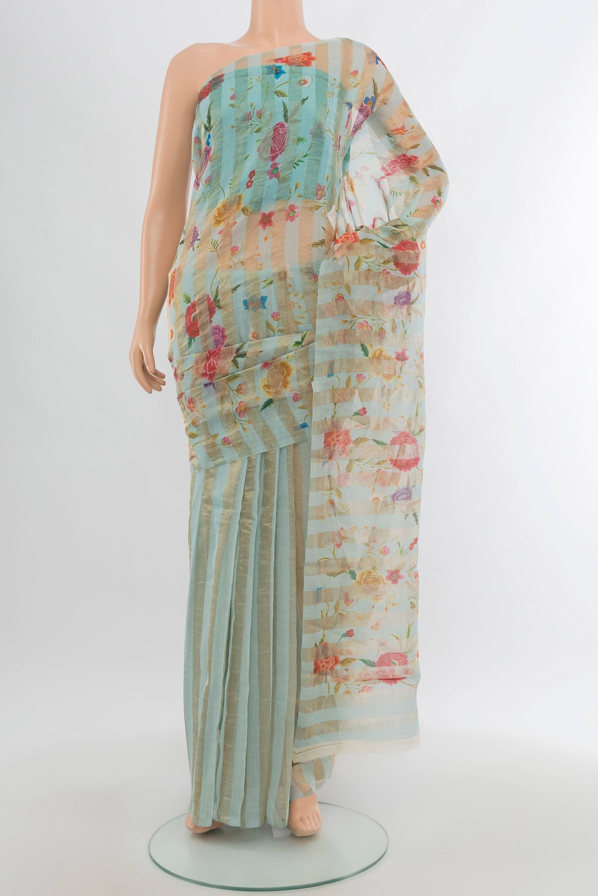 Light Blue Maheshwari Silk Cotton Saree with Floral Print on the body and Without Border.  displayed on a mannequin