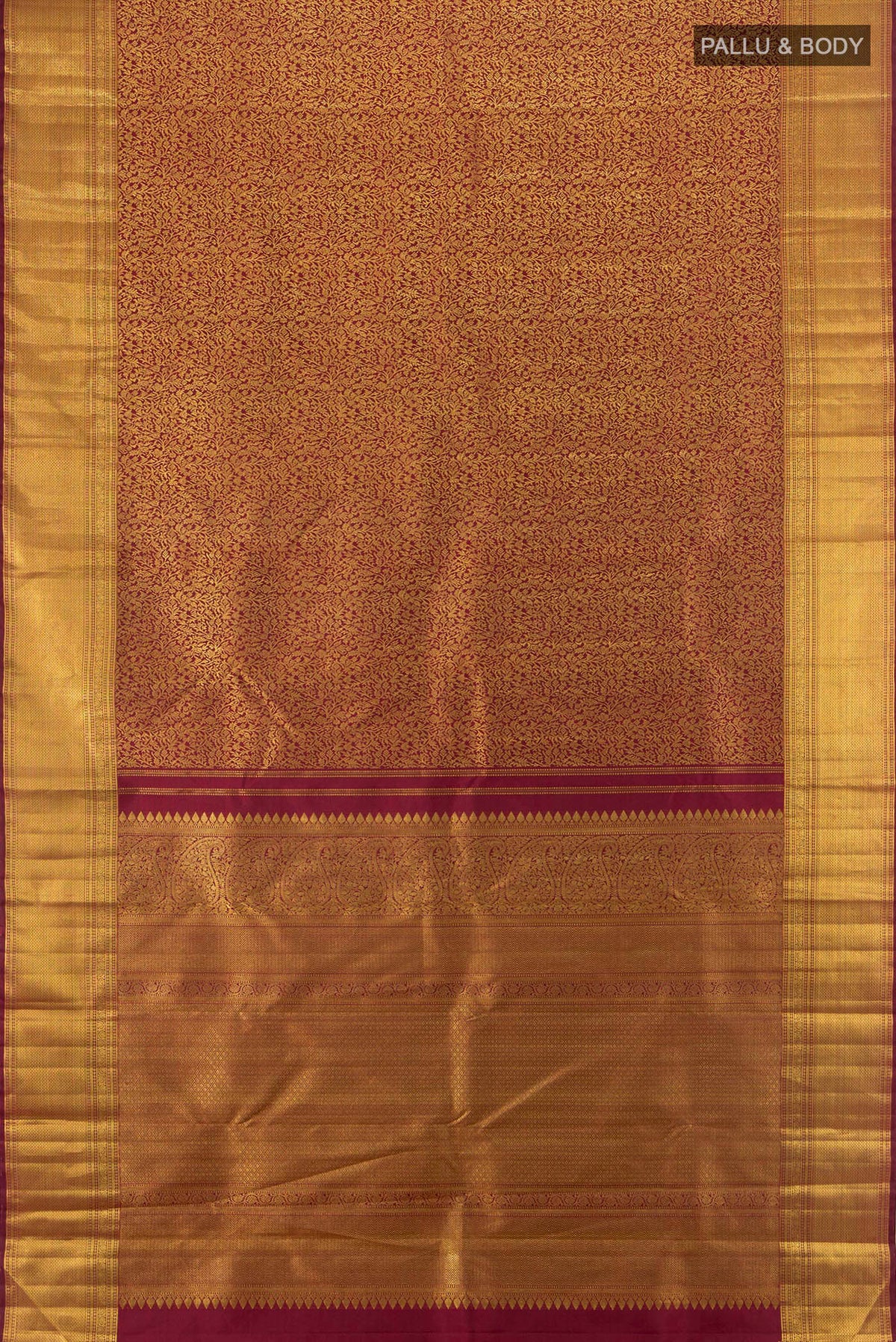 Flat view of Maroon Kanchipuram Silk Saree with Zari Brocade on the body and Zari Border. 