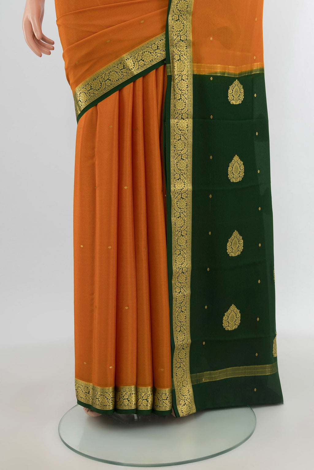 Pleats and pallu of Mustard Mysore Crepe Saree with Zari Butta on the body and Zari Border. 