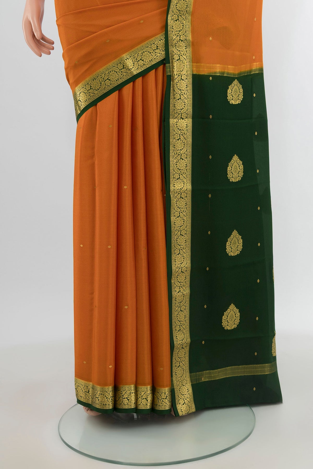 Pleats and pallu of Mustard Mysore Crepe Saree with Zari Butta on the body and Zari Border. 