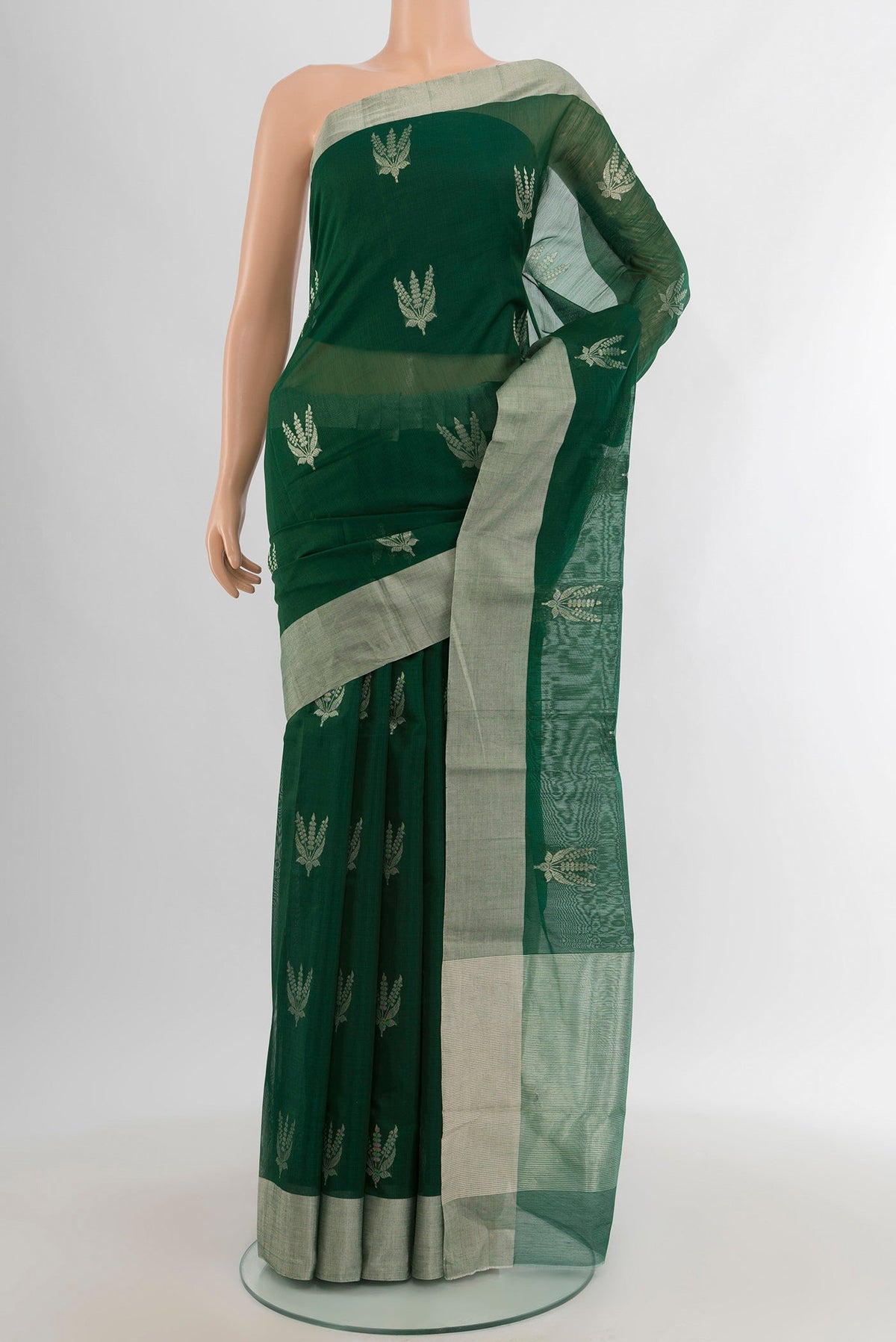 Bottle Green Chanderi Silk Cotton Saree with Zari Butta on the body and Zari Border.  displayed on a mannequin