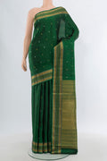 Bottle Green Kanjivaram Silk Saree with Zari Butta on the body and Zari Border.  displayed on a mannequin