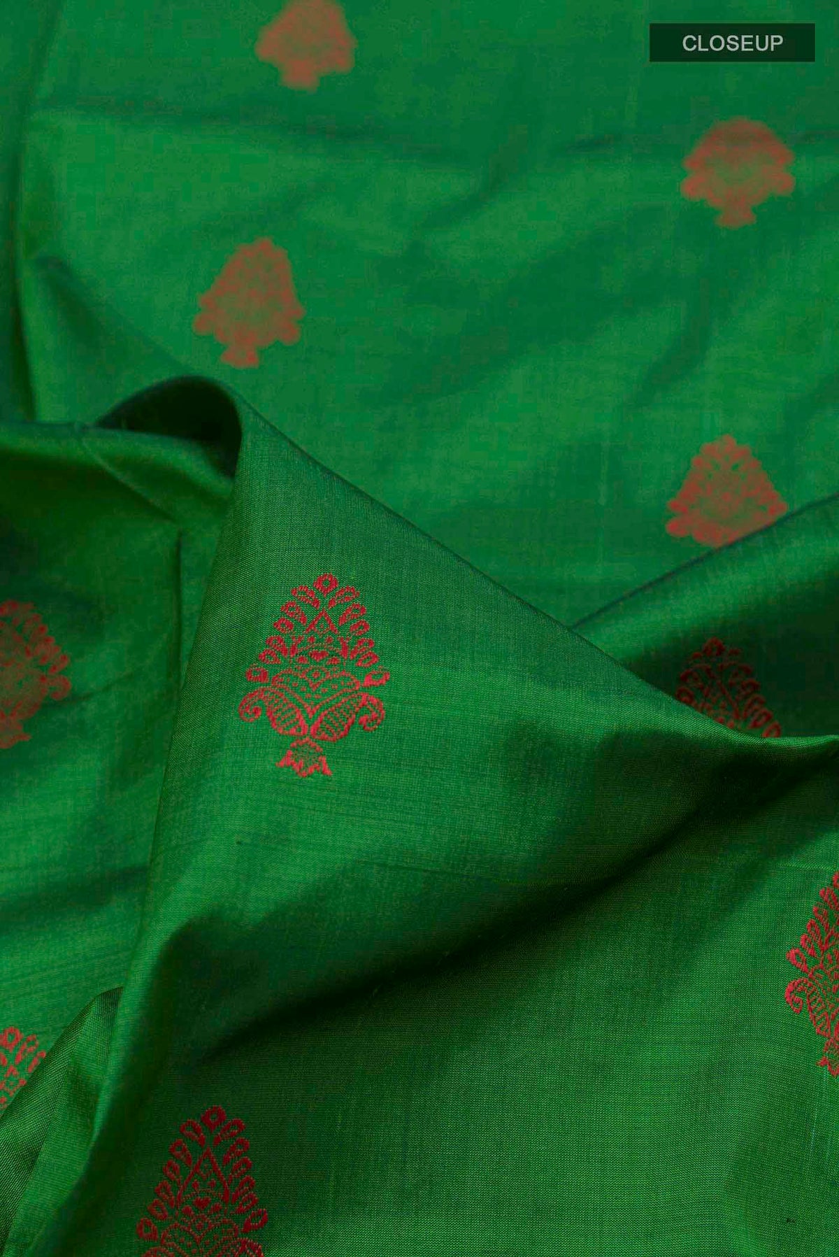 Close up of Green Orissa Silk Saree with Thread Butta on the body and Zari Border displaying folds