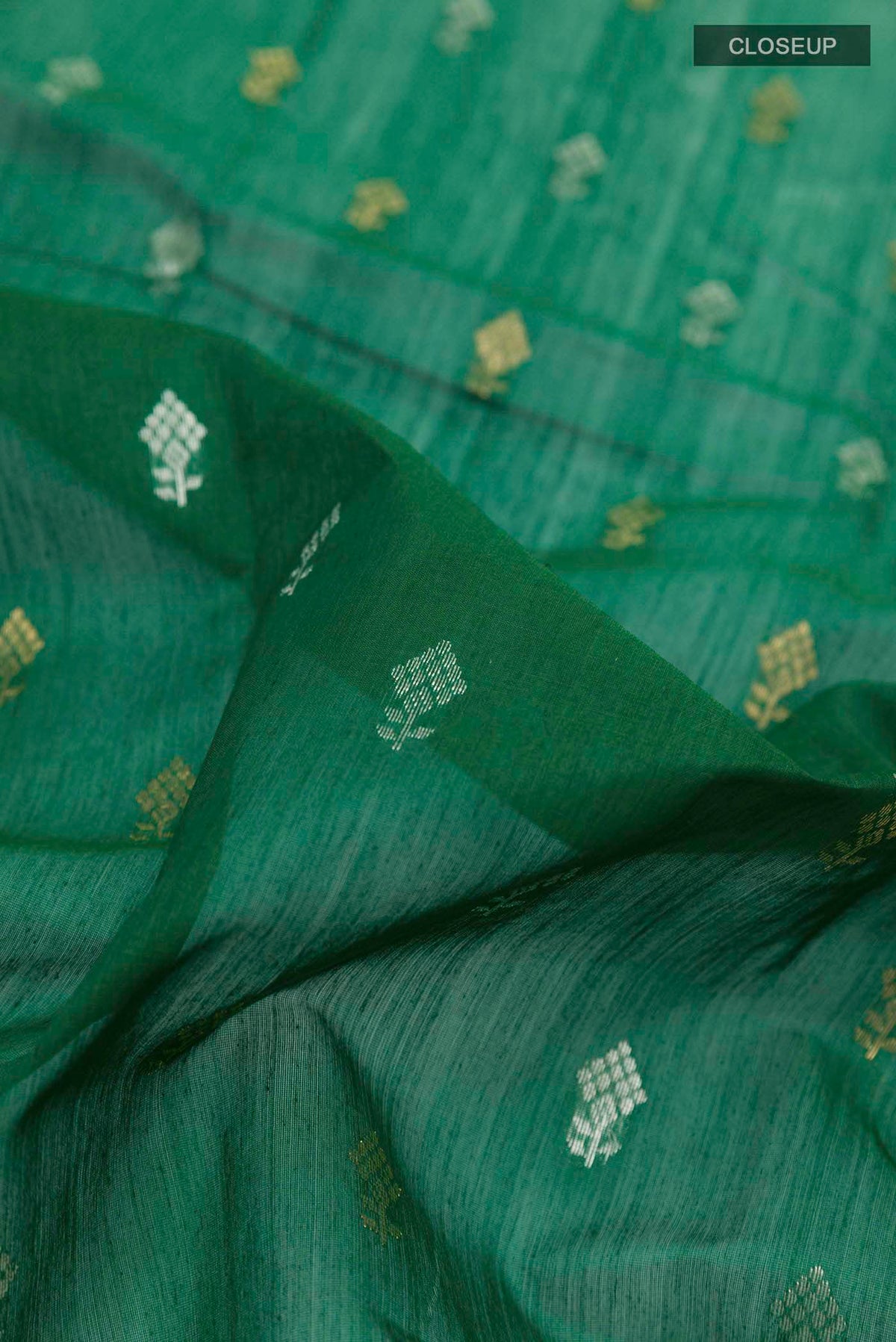 Close up of Green Chanderi Silk Cotton Saree with Zari Butta on the body and Zari Border displaying folds
