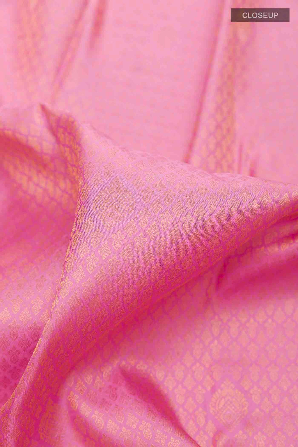 Close up of Pure Silk Pure Zari Pink Kanchipuram Saree with Zari Brocade on the body and Zari Border displaying folds