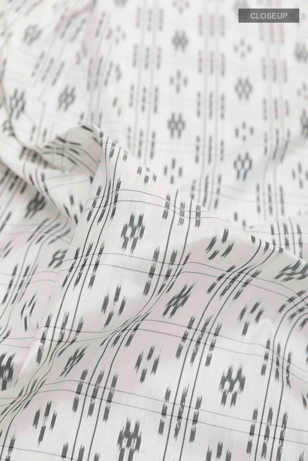 Close up of White Pochampally Silk Saree with Pure Ikat on the body and Plain Border displaying folds
