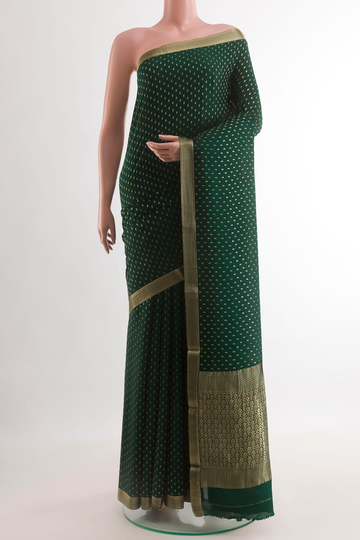 Bottle Green Mysore Crepe Saree with Zari Butta on the body and Zari Border.  displayed on a mannequin