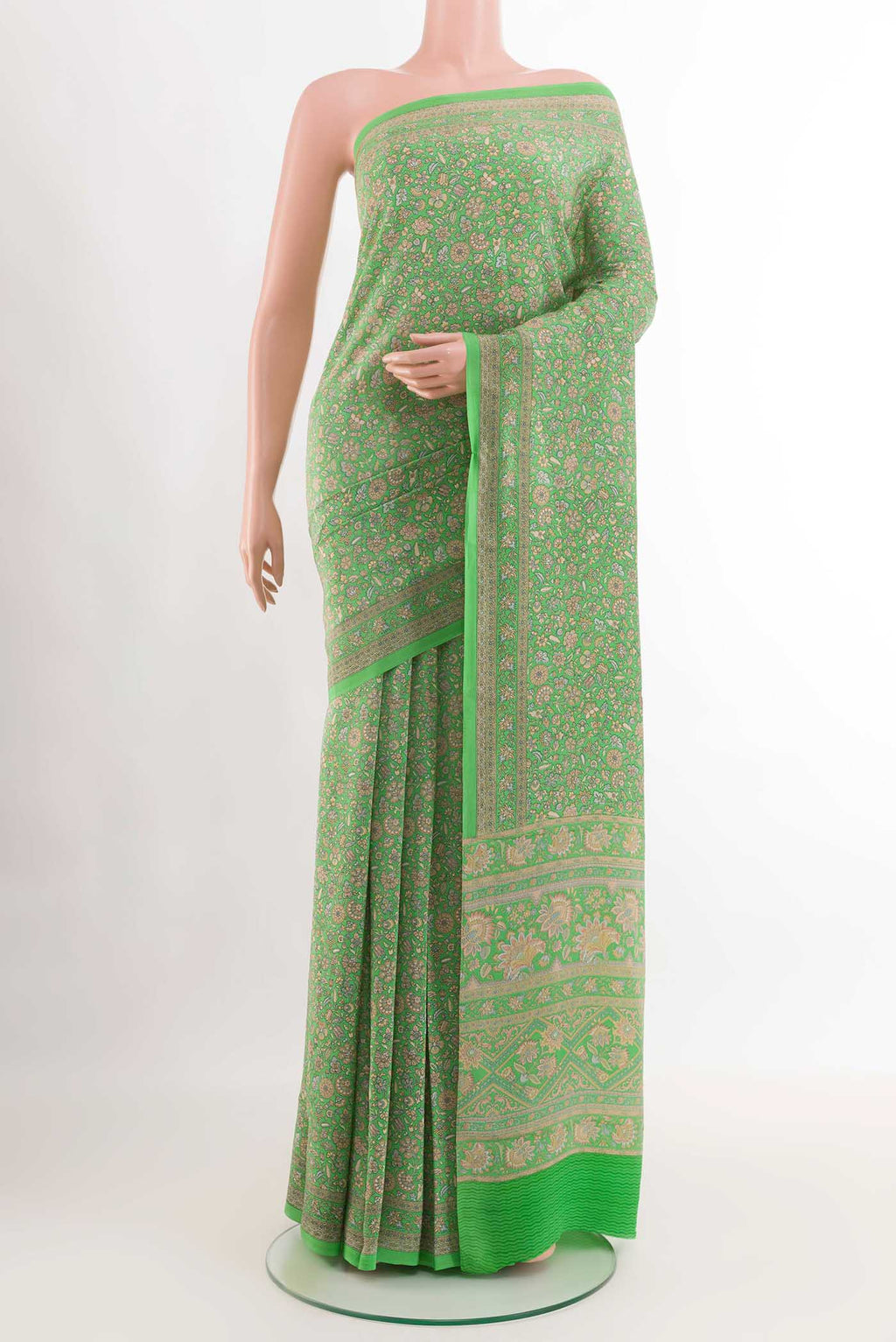 Green Crepe SareePrinted design on the body and Printed Border displayed on a mannequin