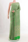 Green Crepe SareePrinted design on the body and Printed Border displayed on a mannequin