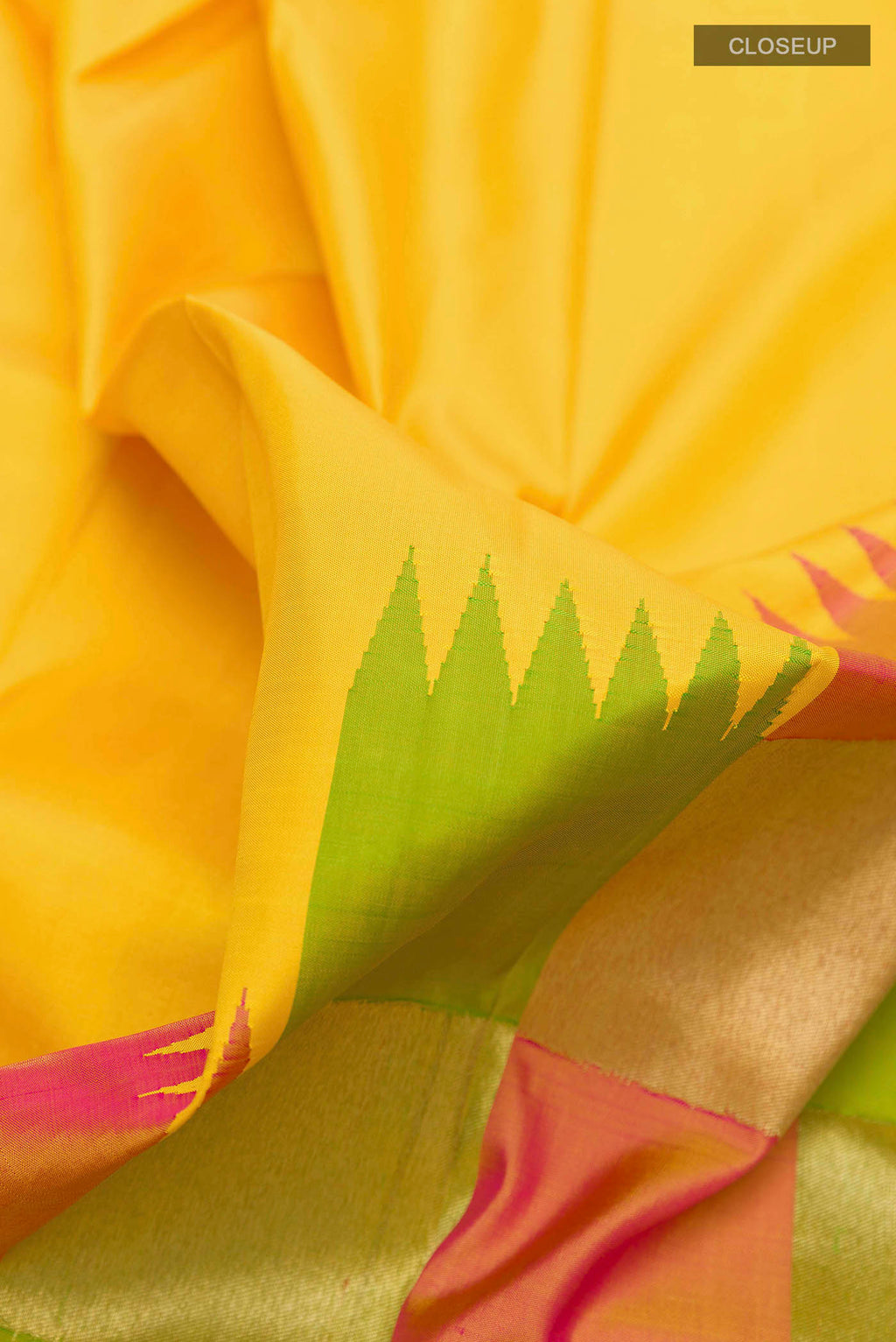 Close up of Yellow Kanchipuram Silk Saree with Plain Body and Rising Temple Border displaying folds