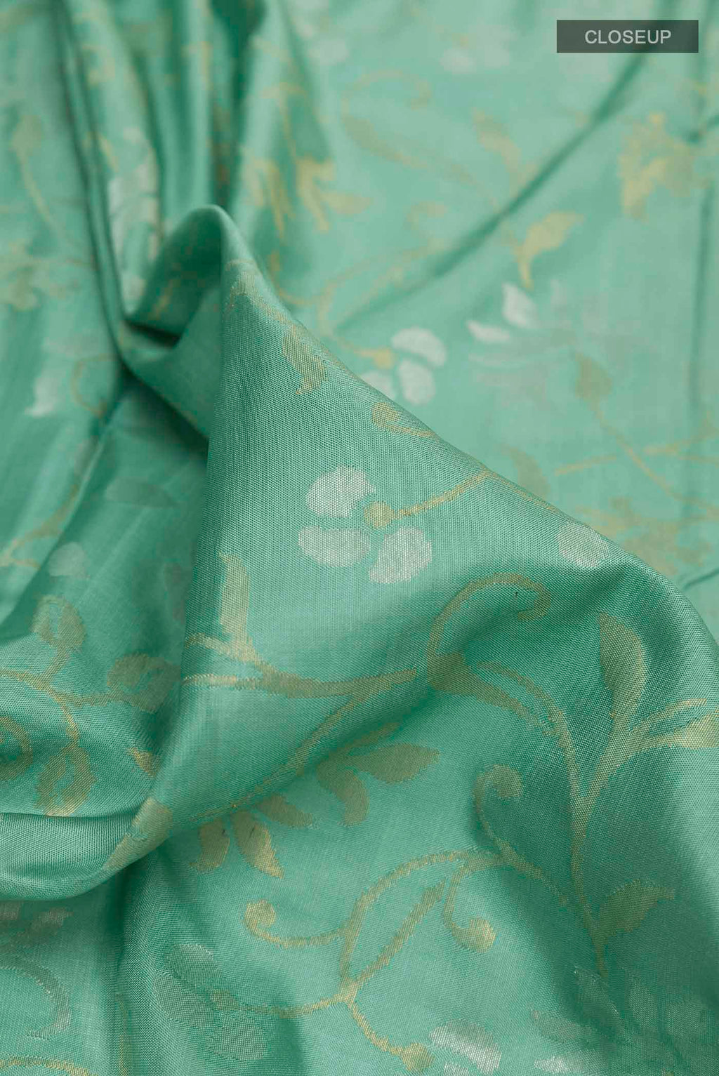 Close up of Pure Silk Pure Zari Sage Green Uppada Saree with Zari Brocade on the body and Zari Border displaying folds