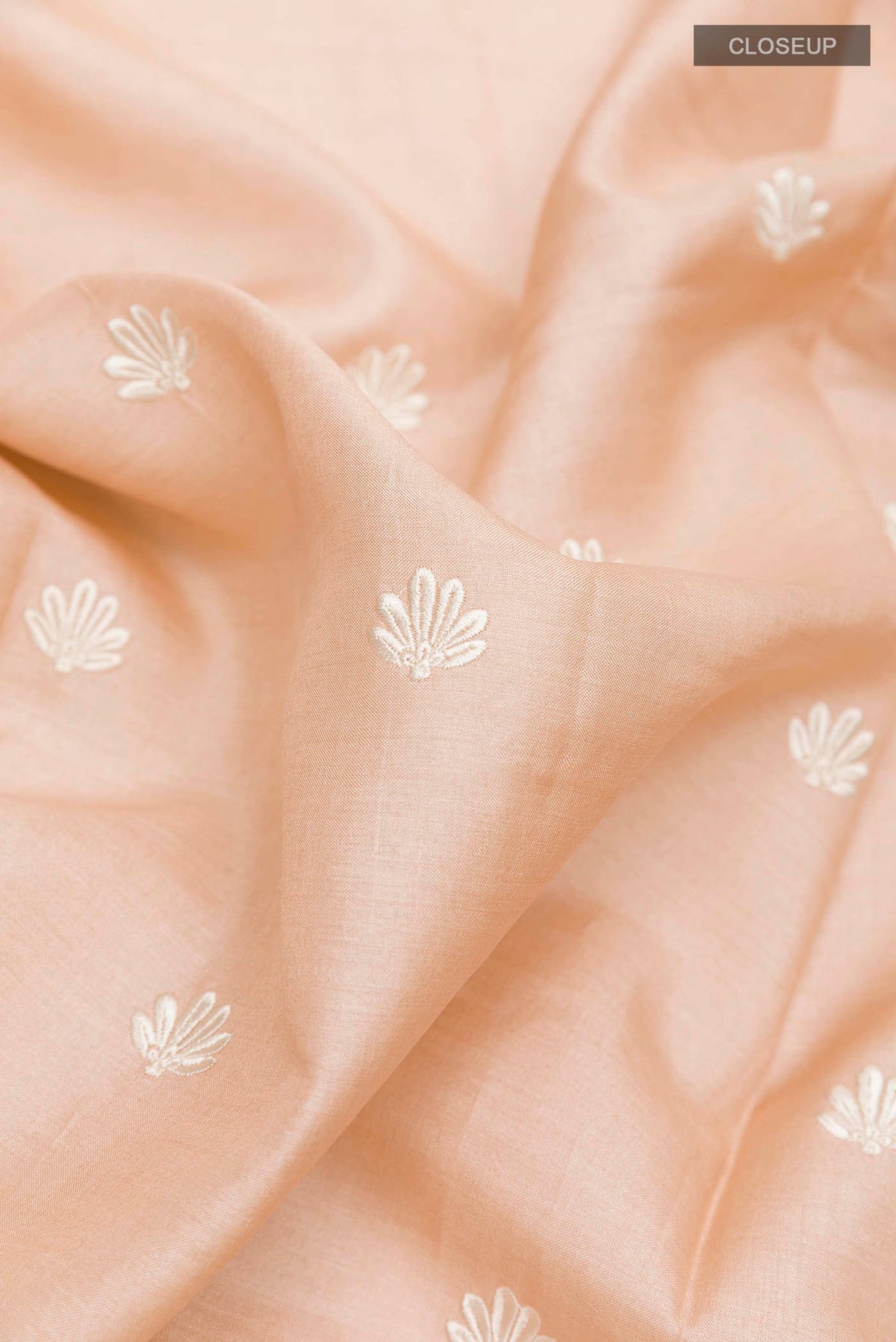 Close up of Imperial Pink Tussar Saree with Thread Butta on the body and Embroidery Border displaying folds
