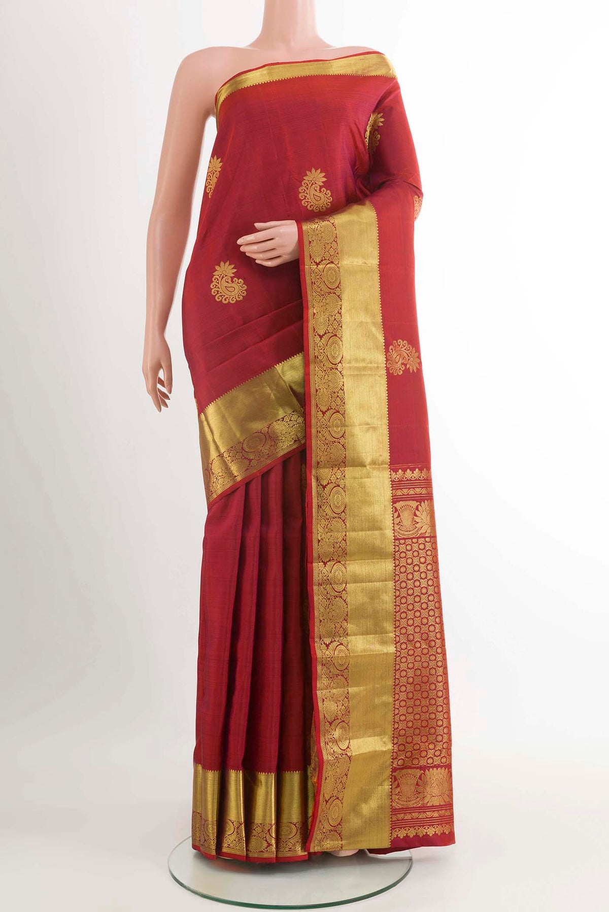 Deep Red Kanchipuram Silk Saree with Zari Butta on the body and Zari Border displayed on a mannequin