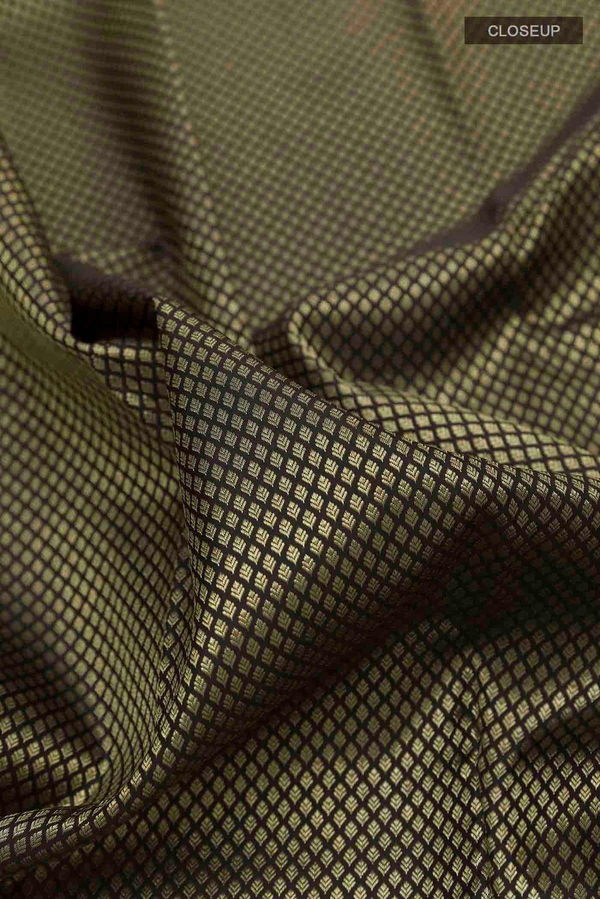 Close up of Black Kanchipuram Silk Saree with Zari Brocade on the body and Zari Border displaying folds