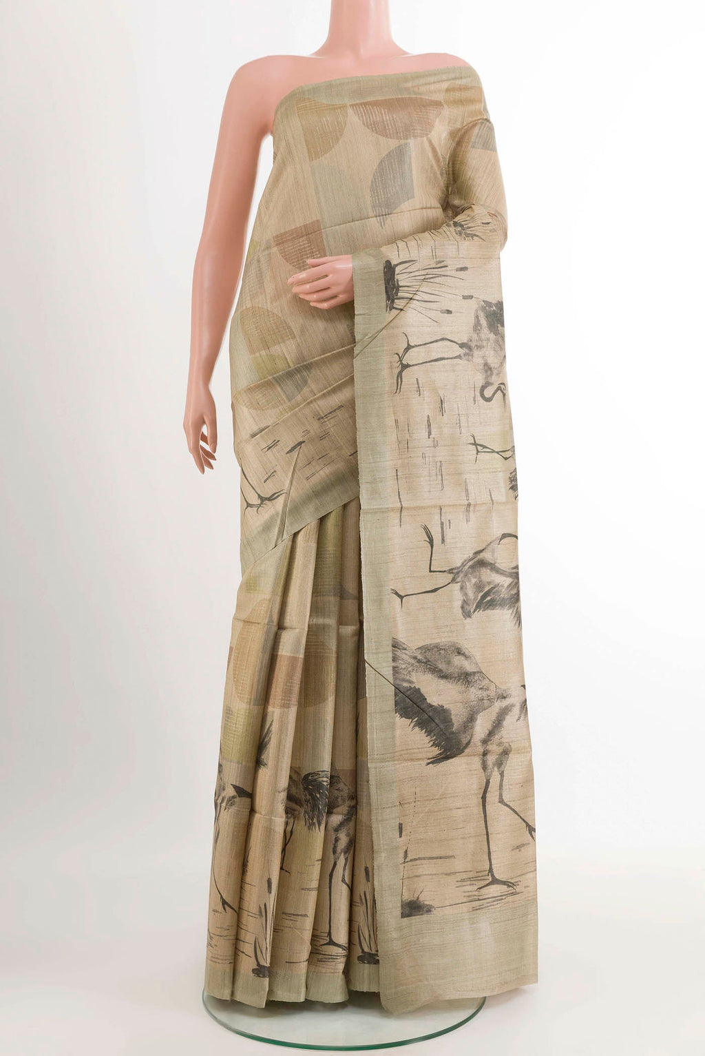 Beige Tussar Saree with Printed design on the body and Zari Border displayed on a mannequin