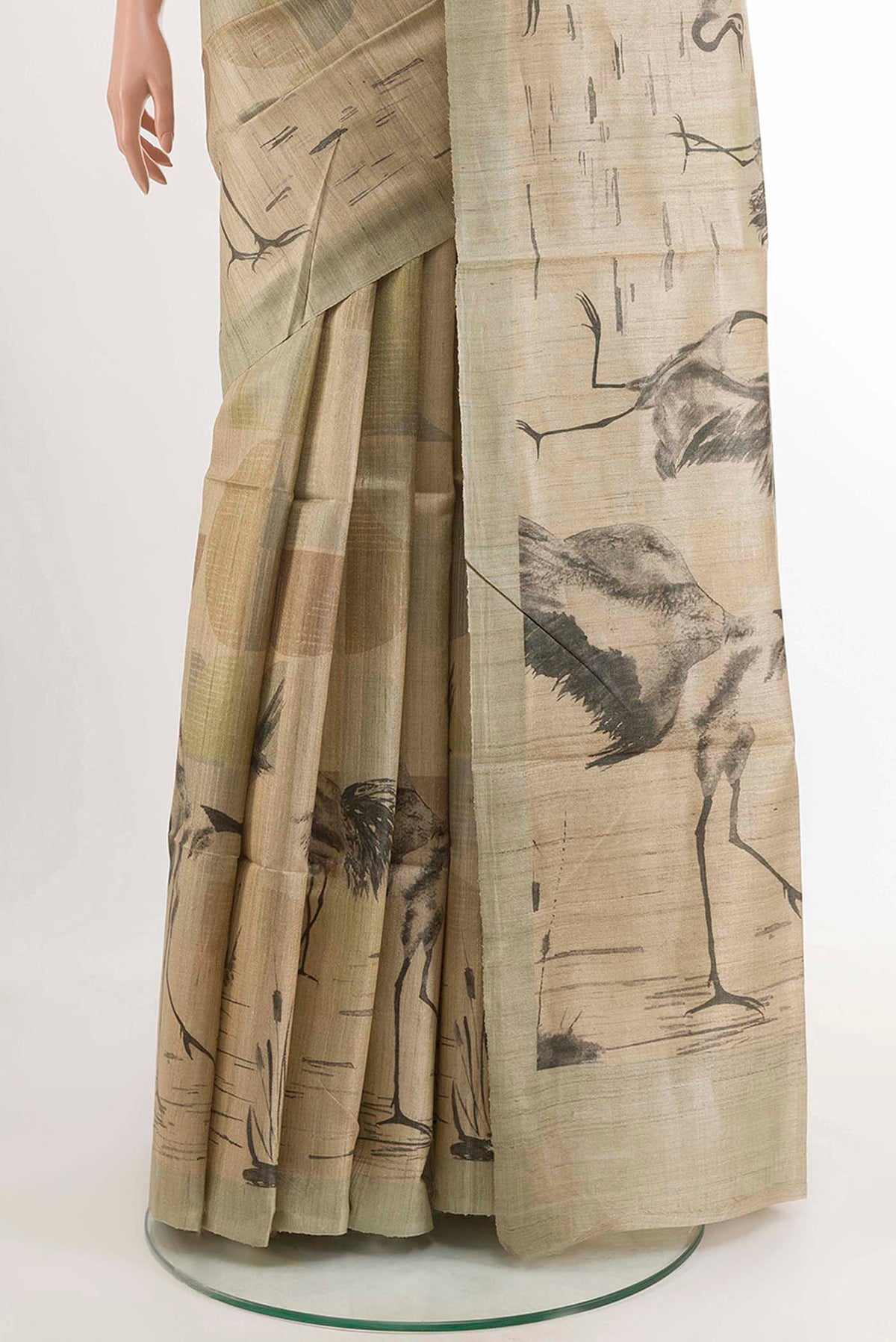 Pleats and pallu of Beige Tussar Saree with Printed design on the body and Zari Border