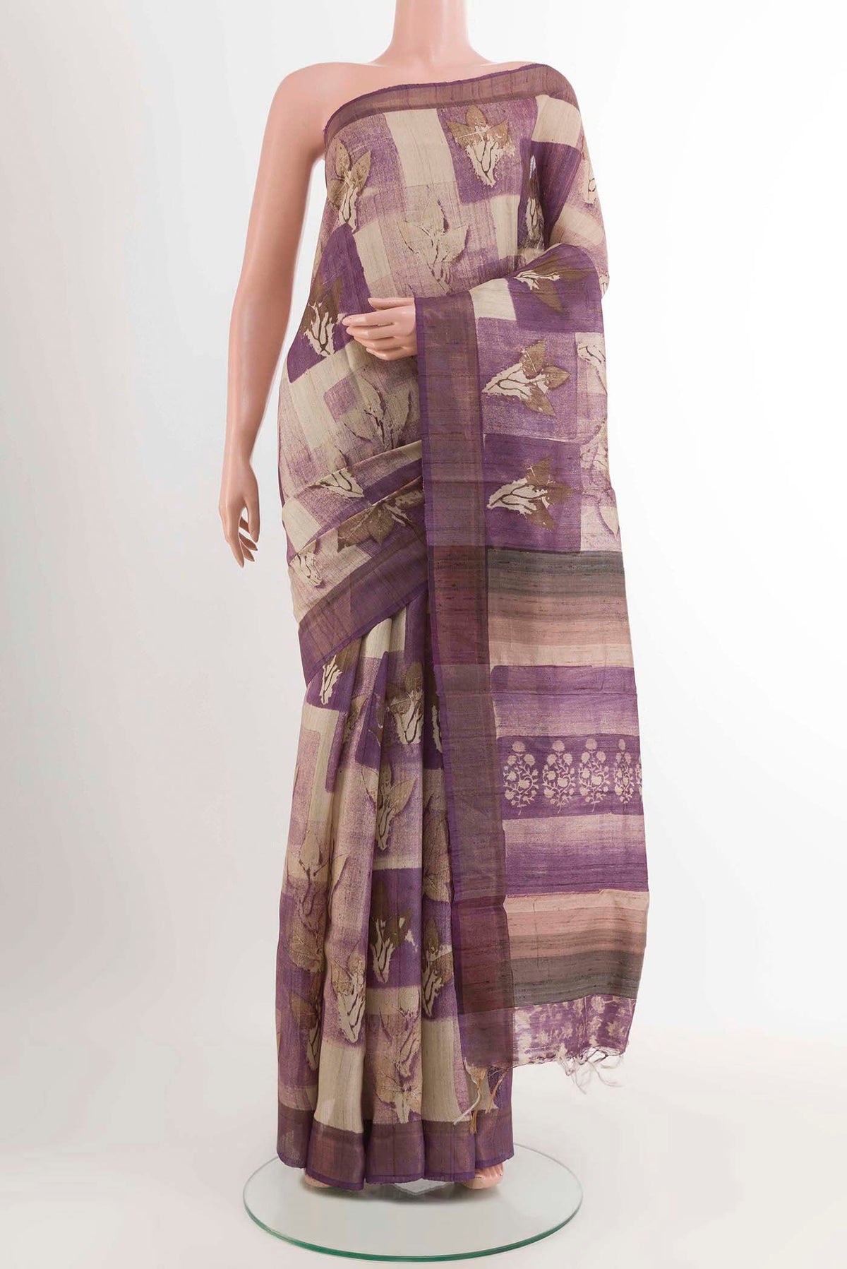 Purple Tussar Saree with Printed design on the body and Zari Border displayed on a mannequin
