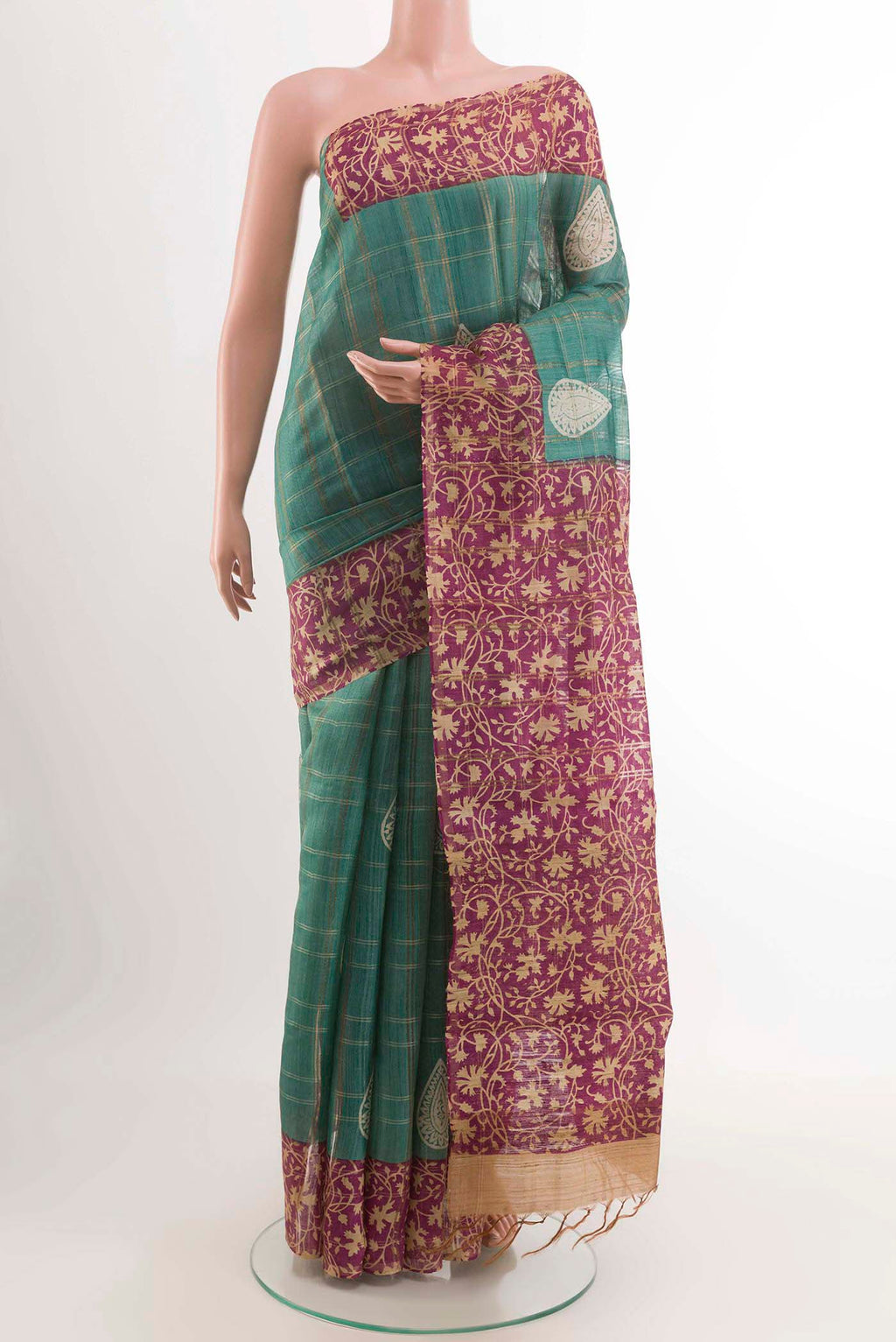 Turquoise Tussar Saree with Checked design on the body and Zari Border displayed on a mannequin