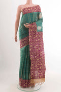 Turquoise Tussar Saree with Checked design on the body and Zari Border displayed on a mannequin