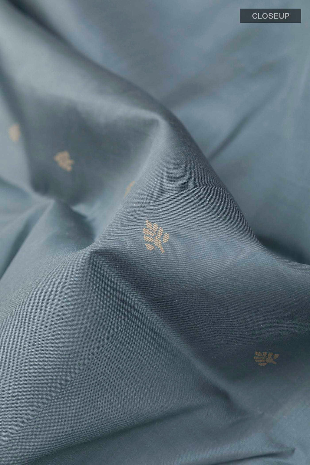 Close up of Grey Kanchipuram Silk Saree with Thread Butta on the body and Thread Embroidery Border displaying folds