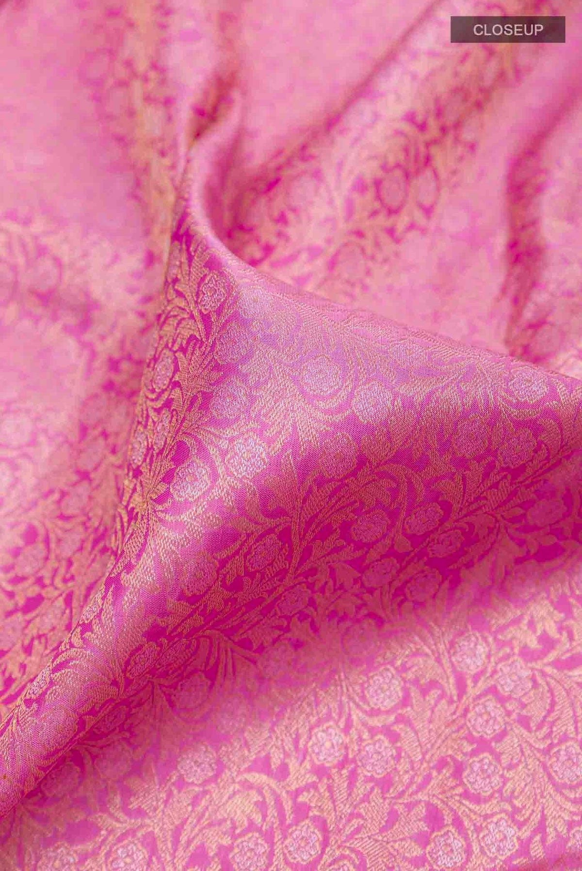 Close up of Pure Silk Pure Zari Pink Kanchipuram Saree with Zari Brocade on the body and Zari Border displaying folds