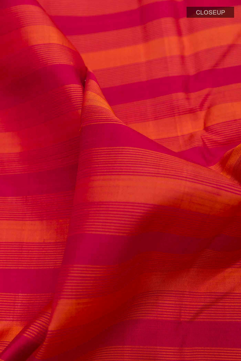 Close up of Maroon Kanchipuram Silk Saree with Stripes on the body and Zari Border displaying folds
