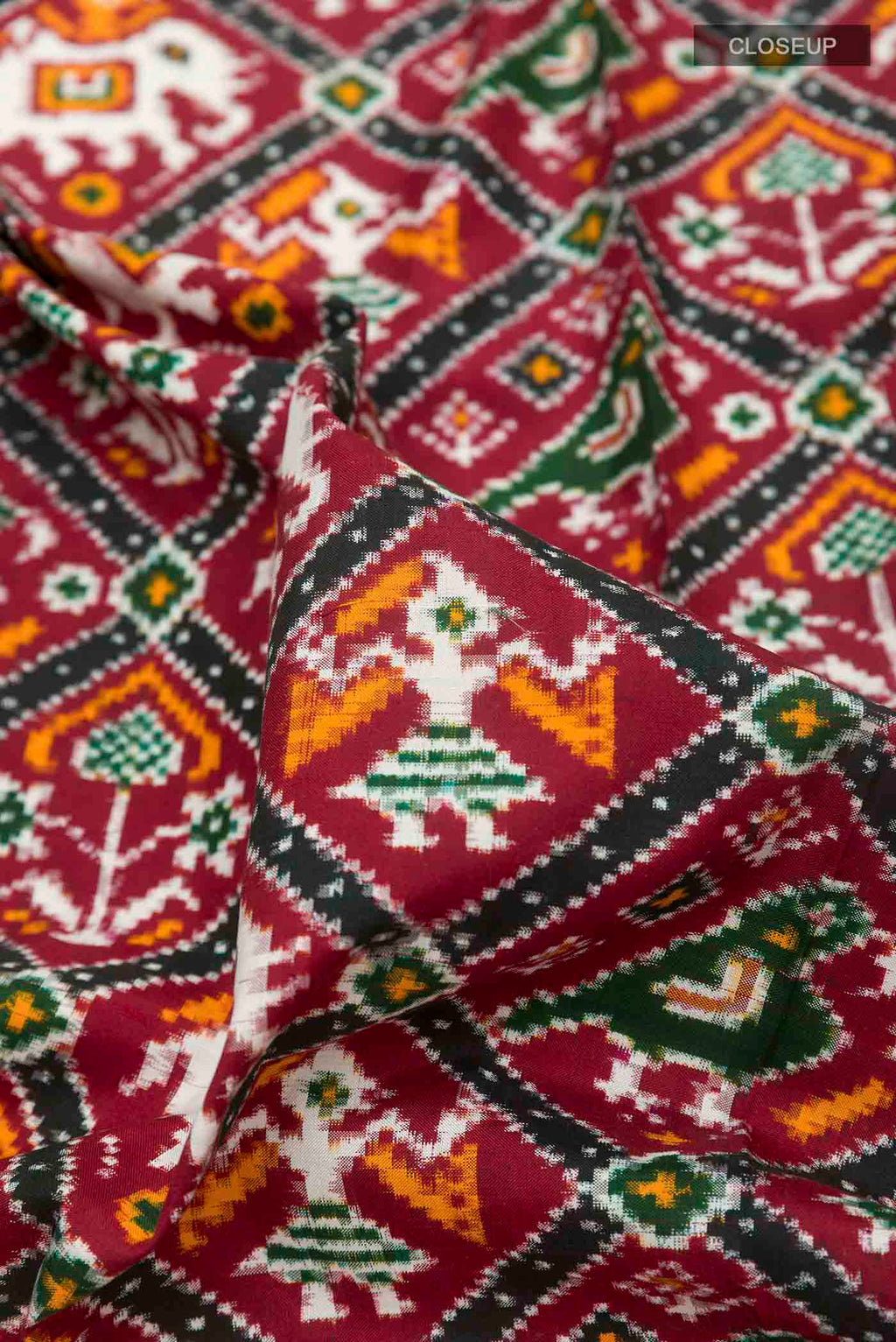 Close up of Maroon Pochampally Silk Saree with Pure Ikat on the body and Ikat Border displaying folds