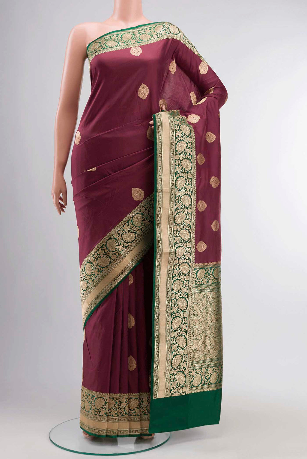 Maroon Banarasi Katan Silk Saree with Zari Butta on the body and Zari Border displayed on a mannequin