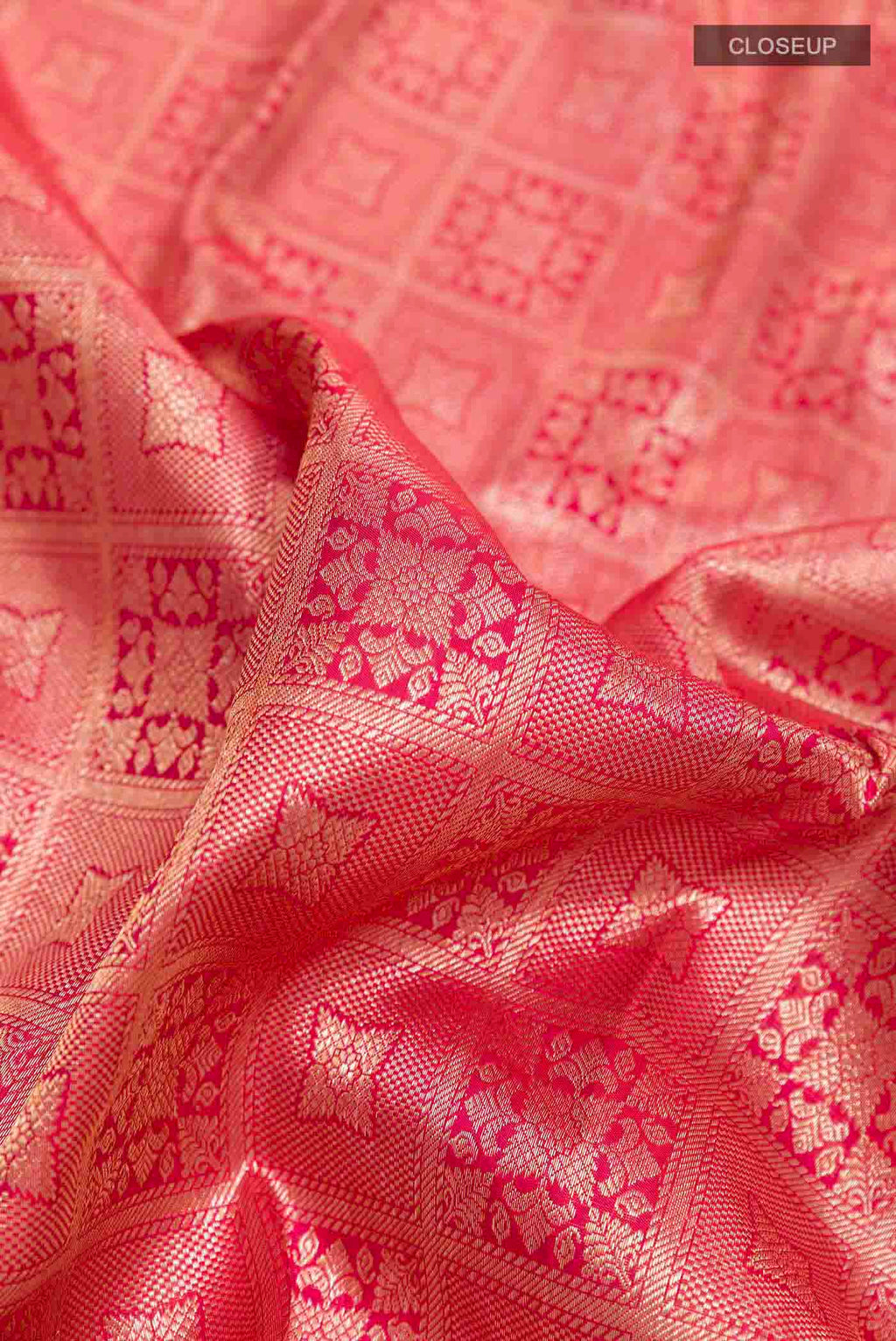 Close up of Red Kanchipuram Silk Saree with Zari Brocade on the body and Zari Border displaying folds