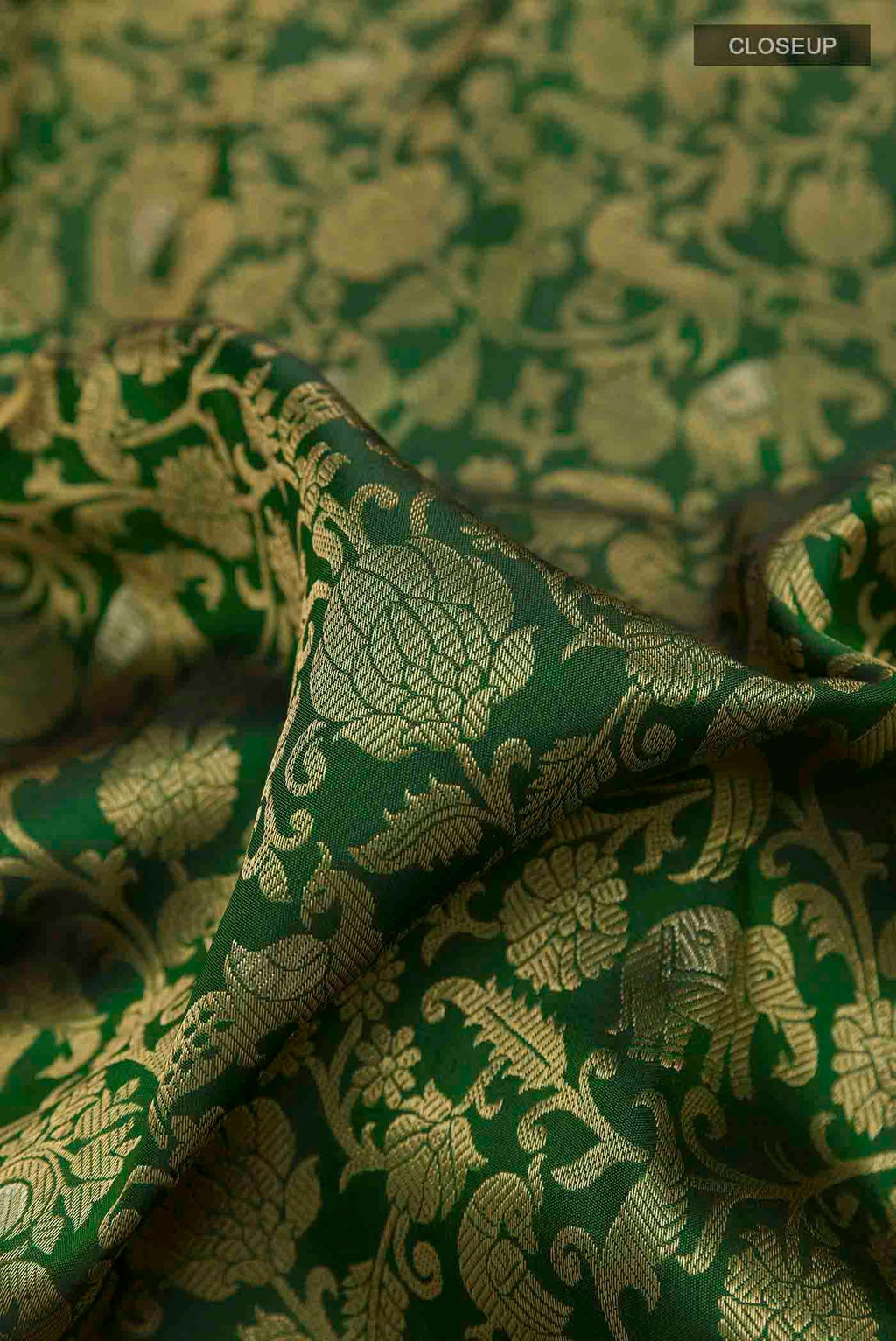 Close up of Green Kanchipuram Silk Saree with Zari Brocade on the body and Zari Border displaying folds