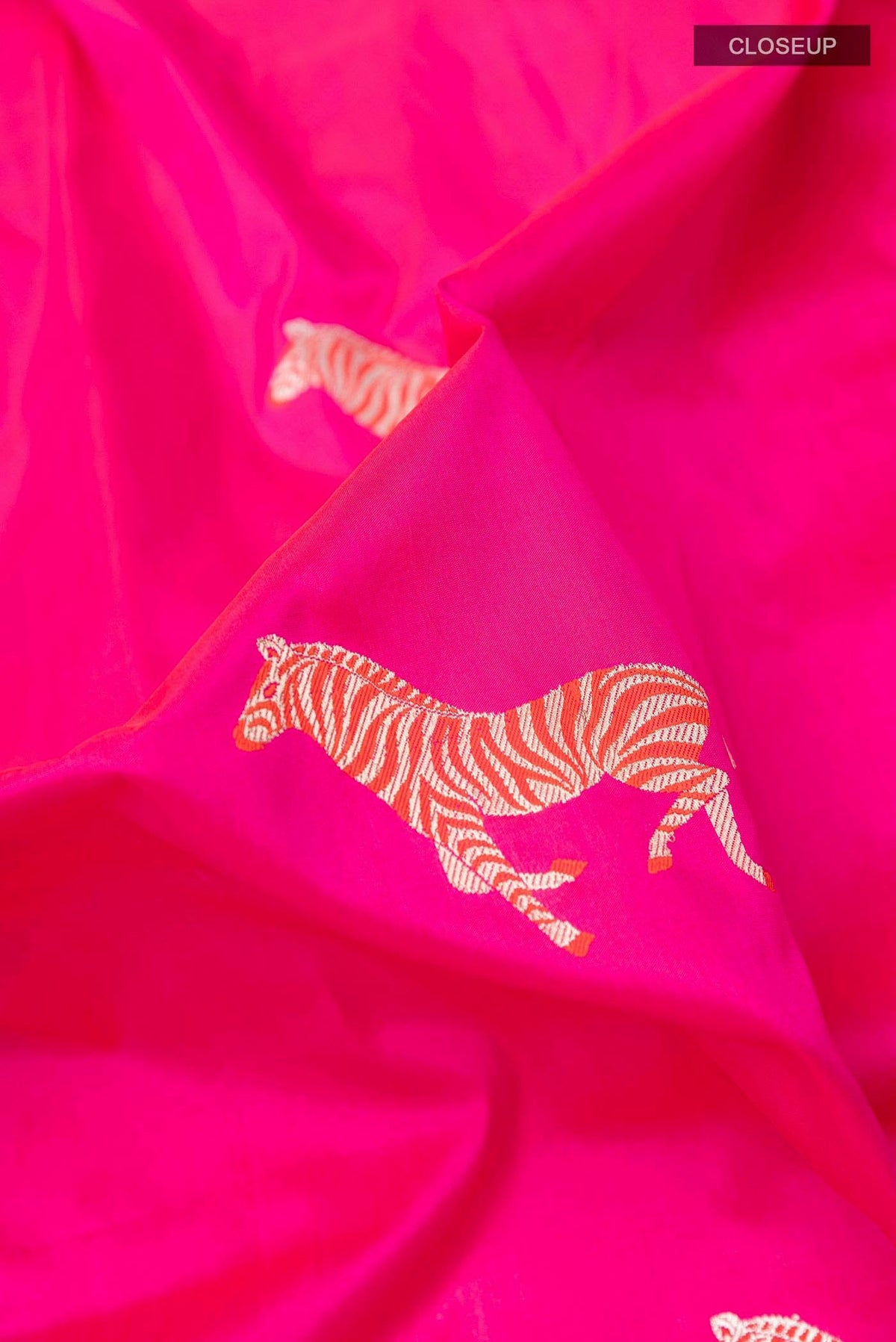 Close up of Pink Banarasi Silk Saree with Zari Butta on the body and Zari Border displaying folds