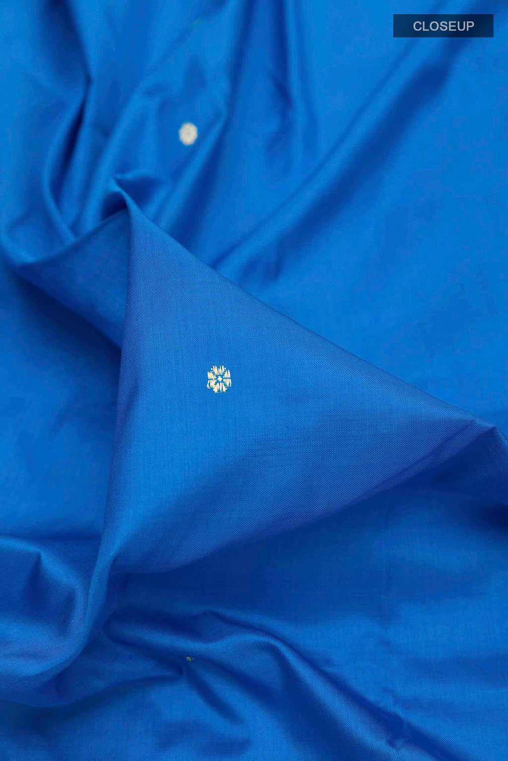 Close up of Blue Paithani Silk Saree with Zari Butta on the body and Zari Border displaying folds