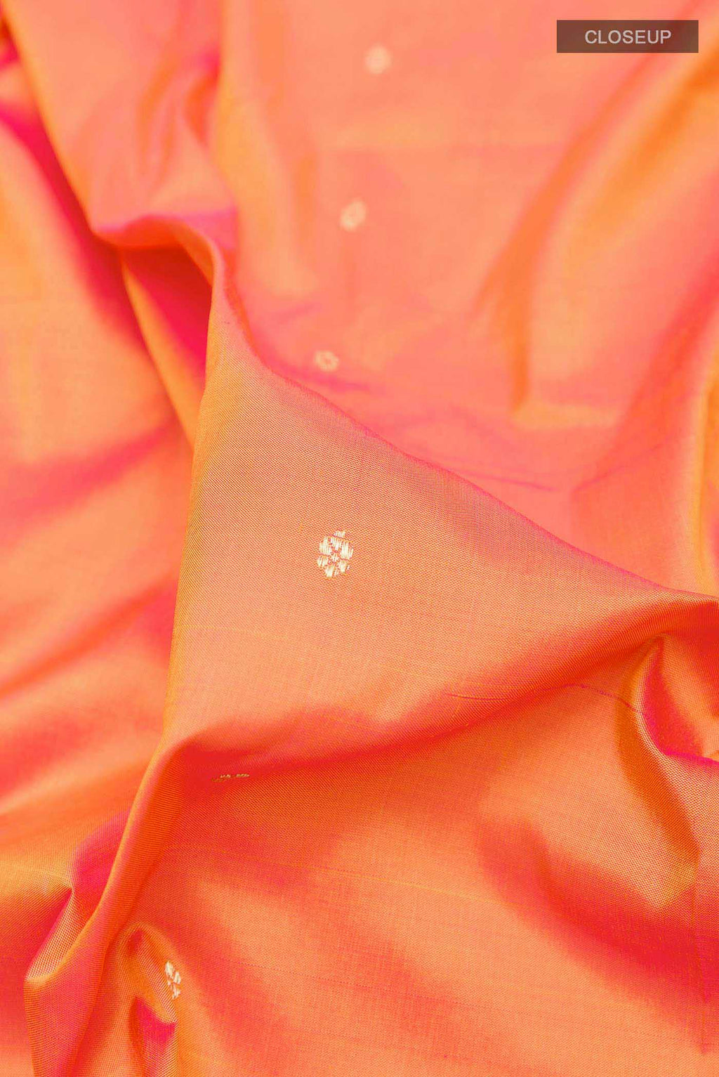 Close up of Orange Dual Tone Paithani Silk Saree with Zari Butta on the body and Zari Border displaying folds