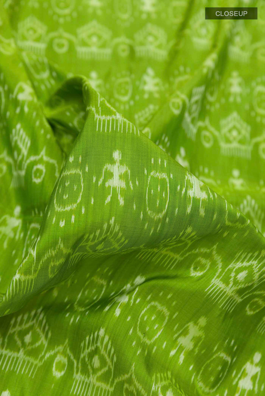 Close up of Green Orissa Silk Saree with Pure Ikat on the body and Thread Border displaying folds