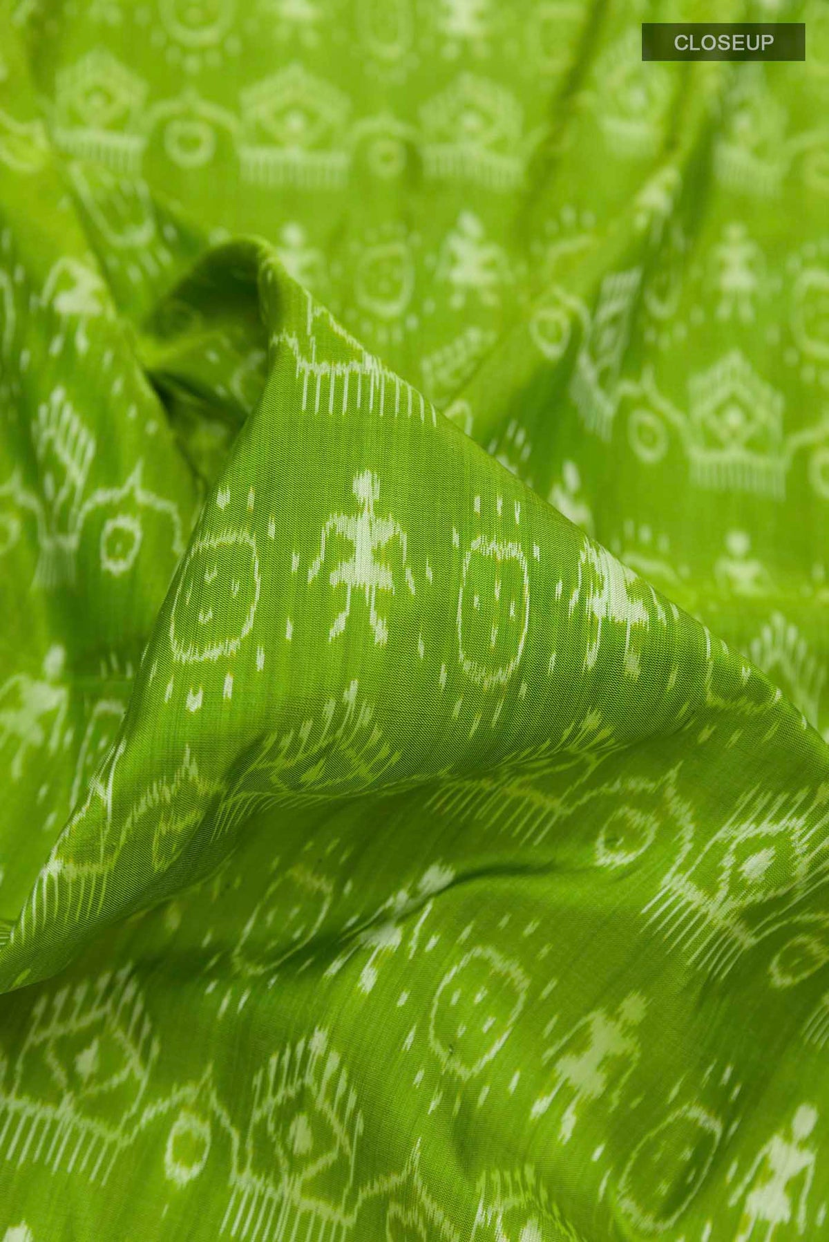 Close up of Green Orissa Silk Saree with Pure Ikat on the body and Thread Border displaying folds