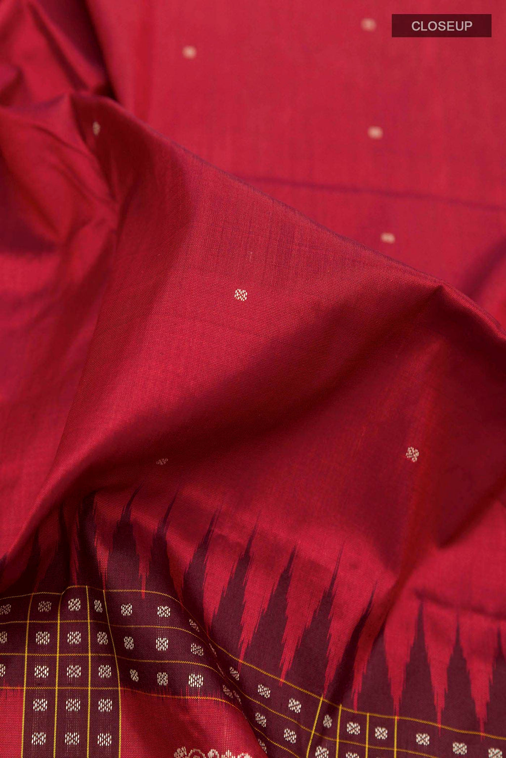 Close up of Maroon Orissa Silk Saree with Thread Butta on the body and Thread Border displaying folds