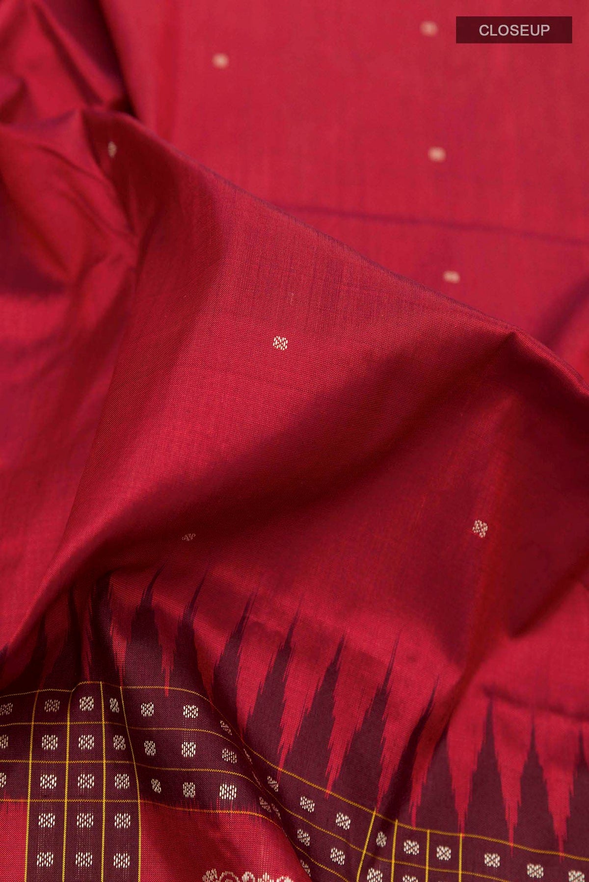 Close up of Maroon Orissa Silk Saree with Thread Butta on the body and Thread Border displaying folds