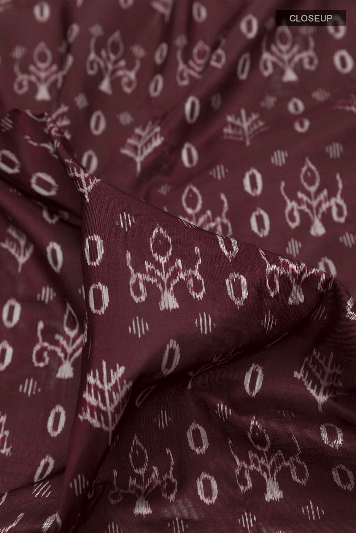 Close up of Brown Orissa Silk Saree with Pure Ikat on the body and Thread Border displaying folds