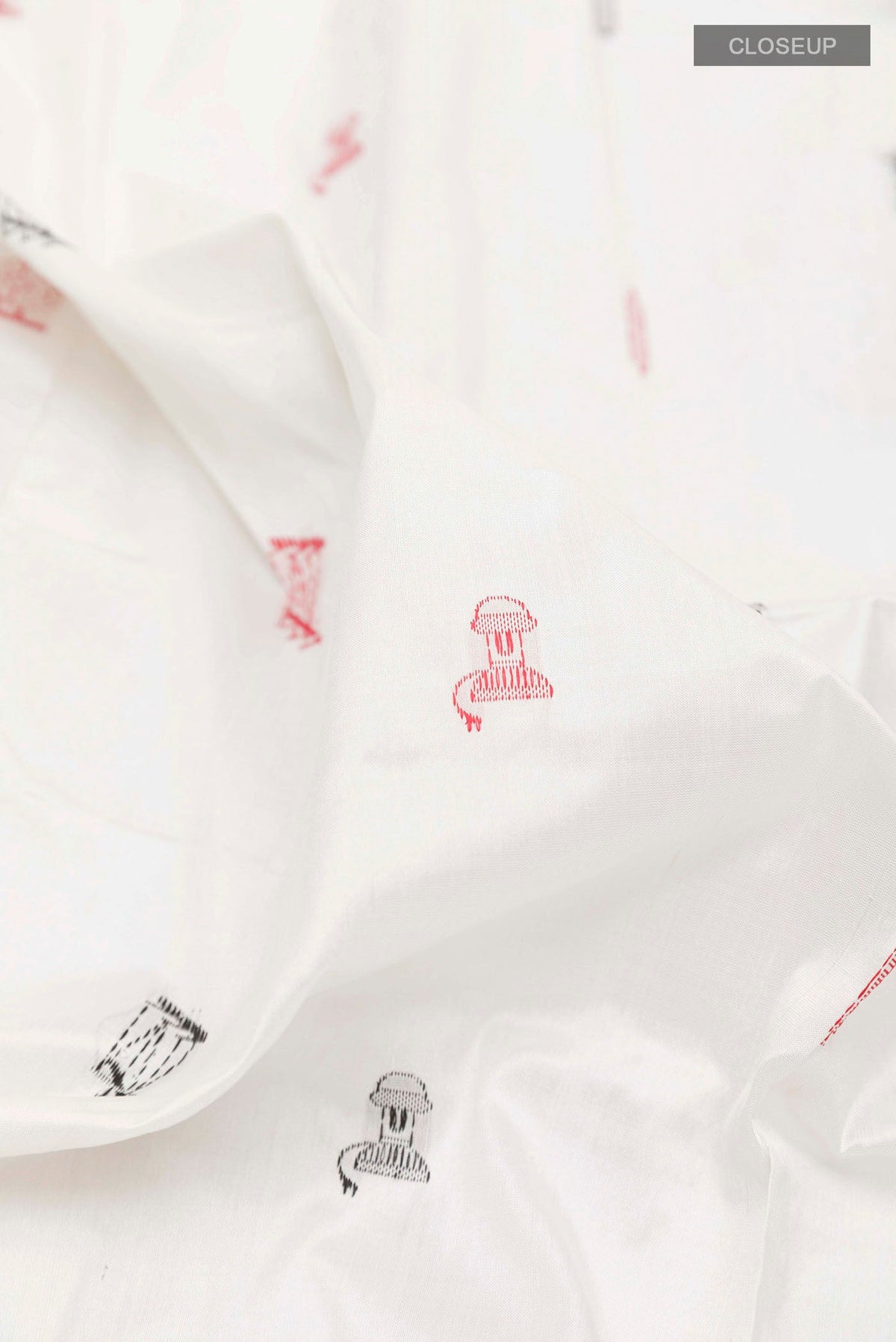 Close up of White Orissa Silk Saree with Thread Butta on the body and Zari Border displaying folds