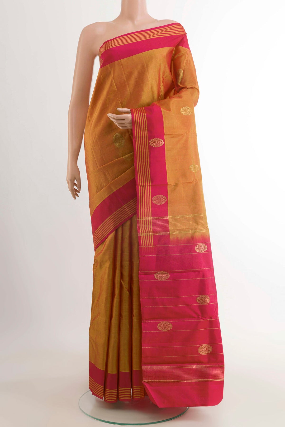 Orange Kanchipuram Silk Saree with Zari Butta on the body and Zari Border displayed on a mannequin