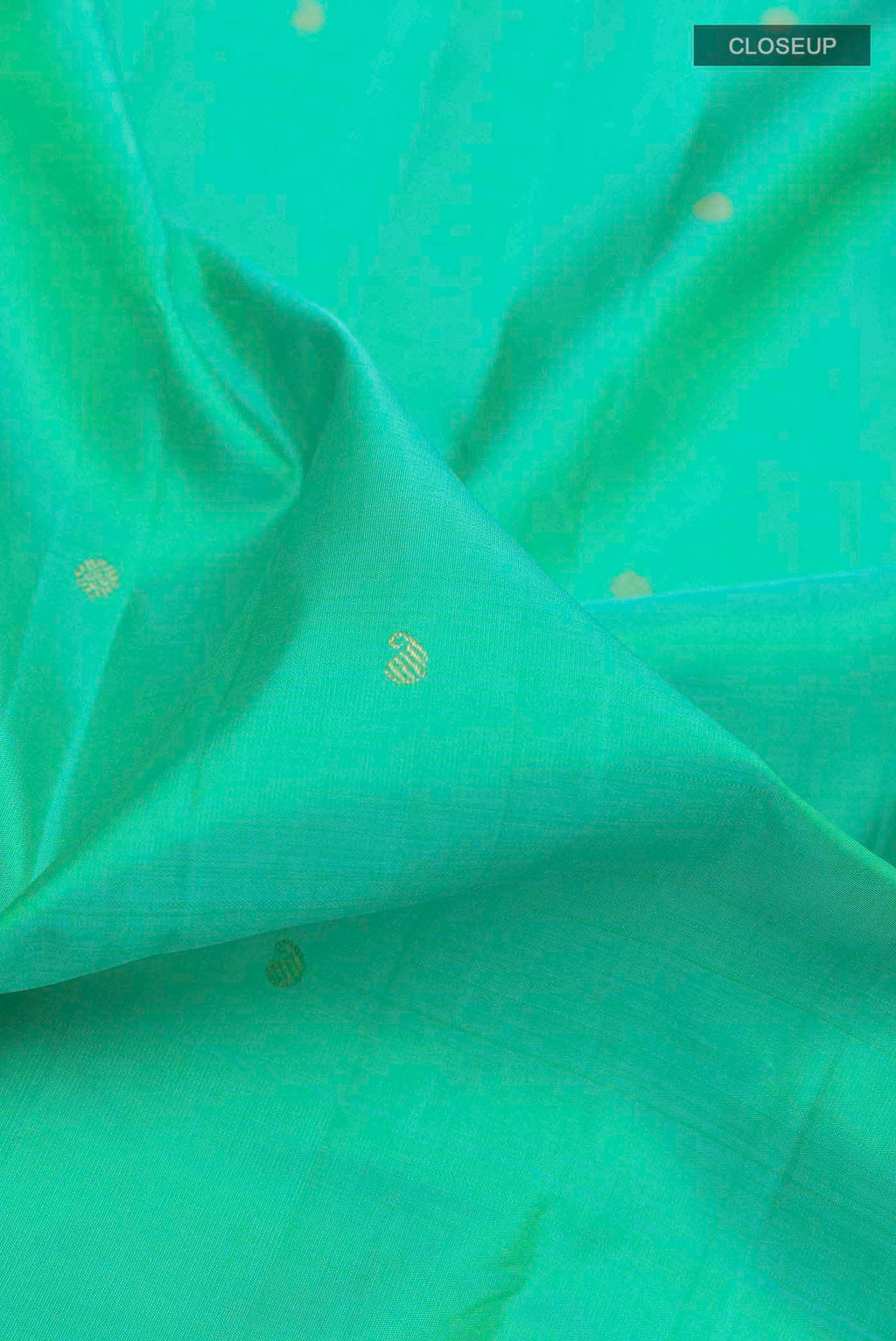 Close up of Sea Green Kanchipuram Silk Saree with Zari Butta on the body and Zari Border displaying folds