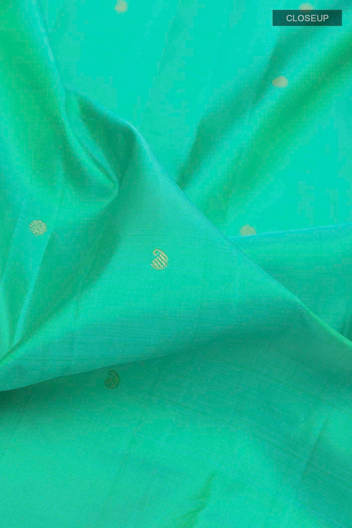 Close up of Sea Green Kanchipuram Silk Saree with Zari Butta on the body and Zari Border displaying folds