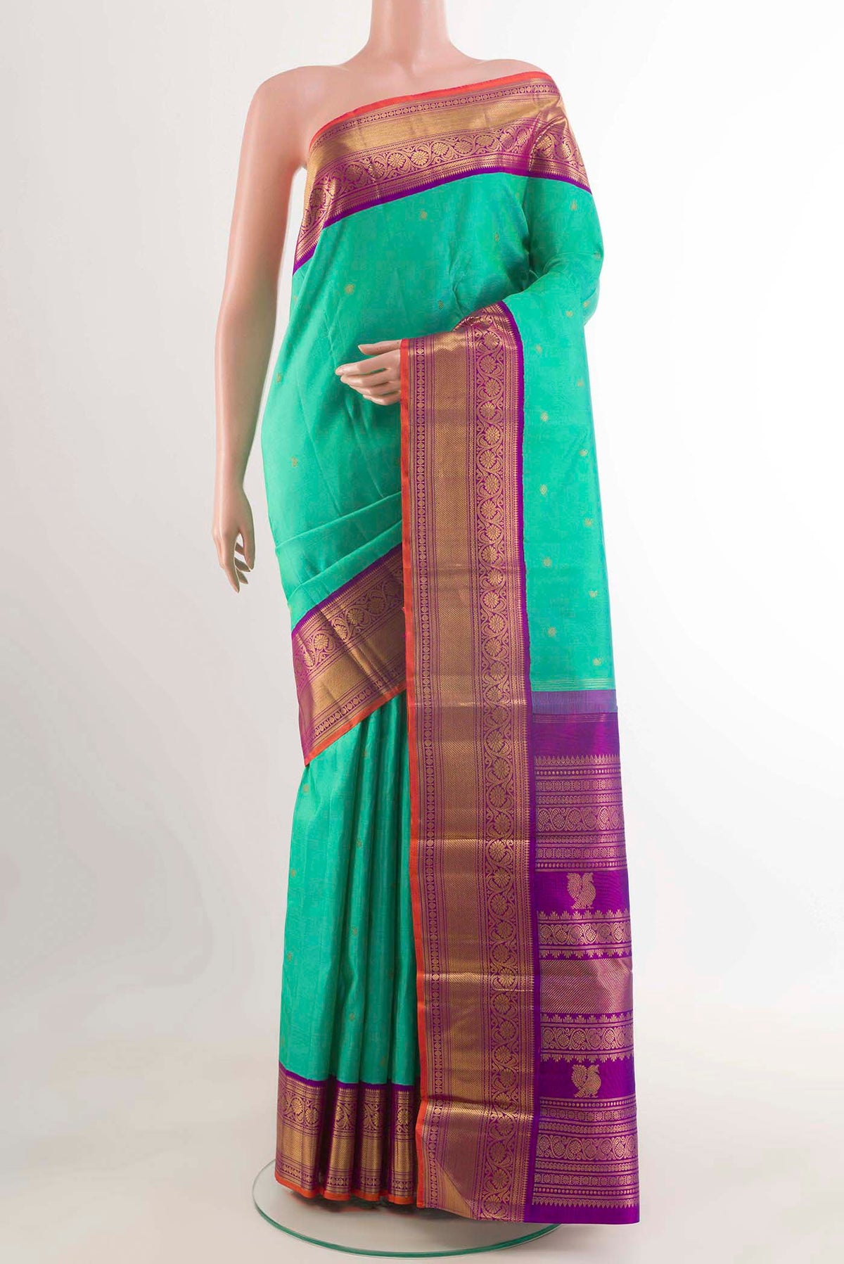 Sea Green Kanchipuram Silk Saree with Zari Butta on the body and Zari Border displayed on a mannequin