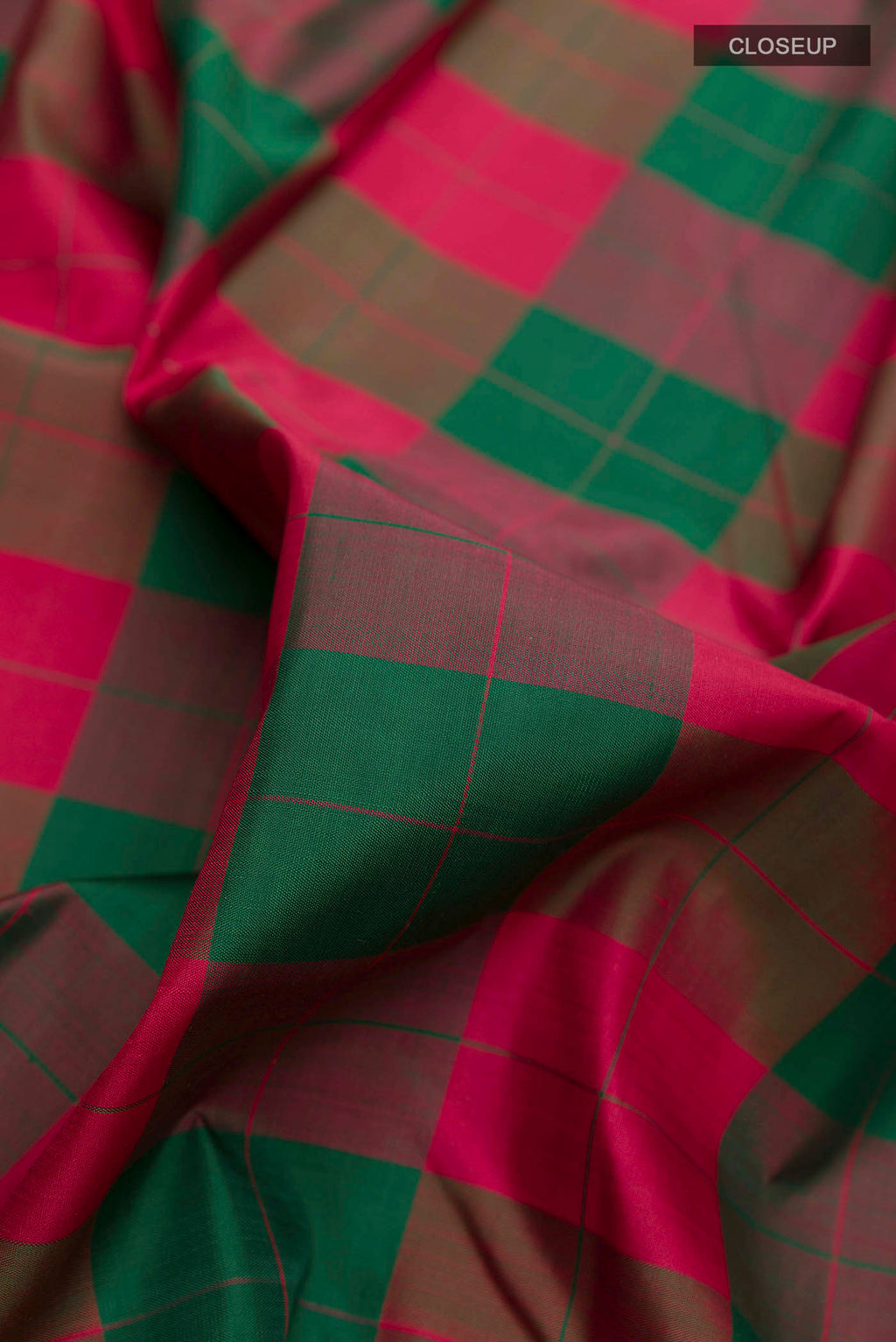 Close up of Multi Color Kanchipuram Silk Saree with Checked design on the body and Thread Border displaying folds