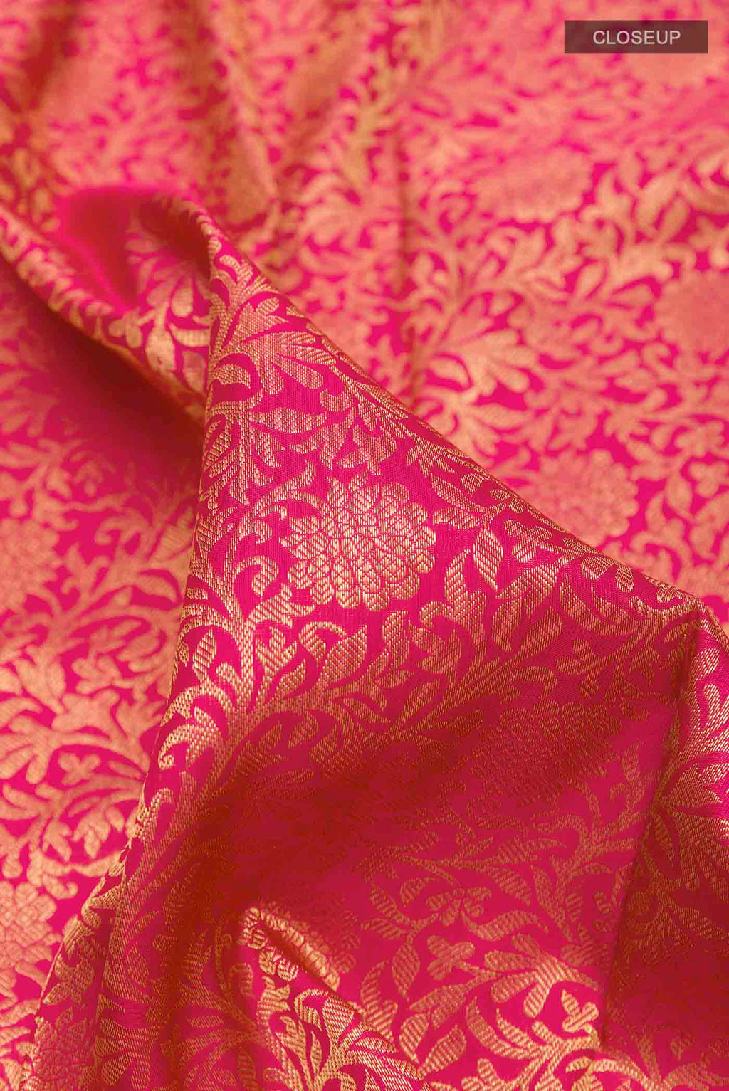 Close up of Pure Silk Pure Zari Pink Kanchipuram Saree with Zari Brocade on the body and Zari Border displaying folds